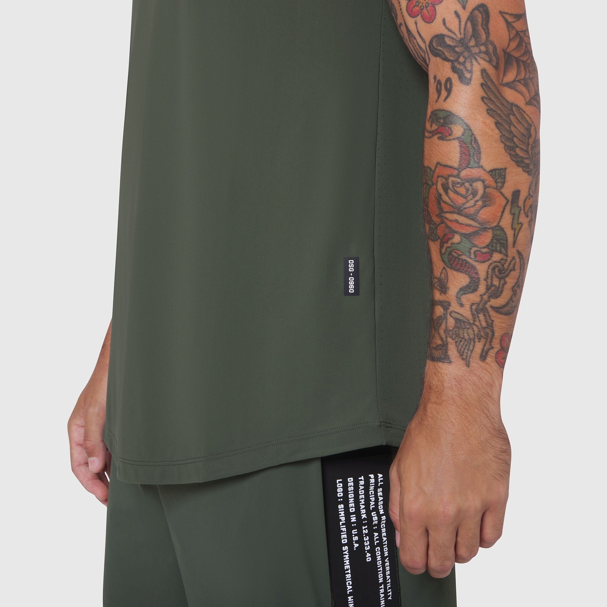 Laser-Vent Tank Top in olive worn by model, side view showing fit and tattoo sleeve