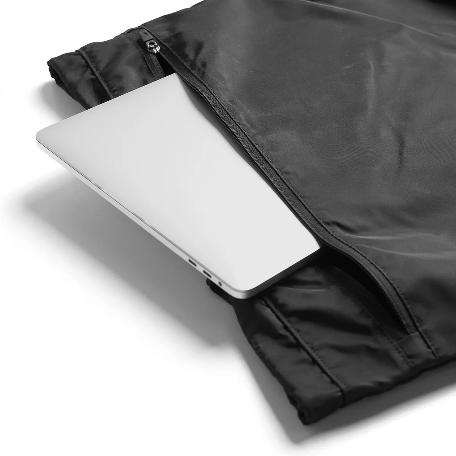 Flatlay Waterproof Drawstring Rec Bag in black with laptop