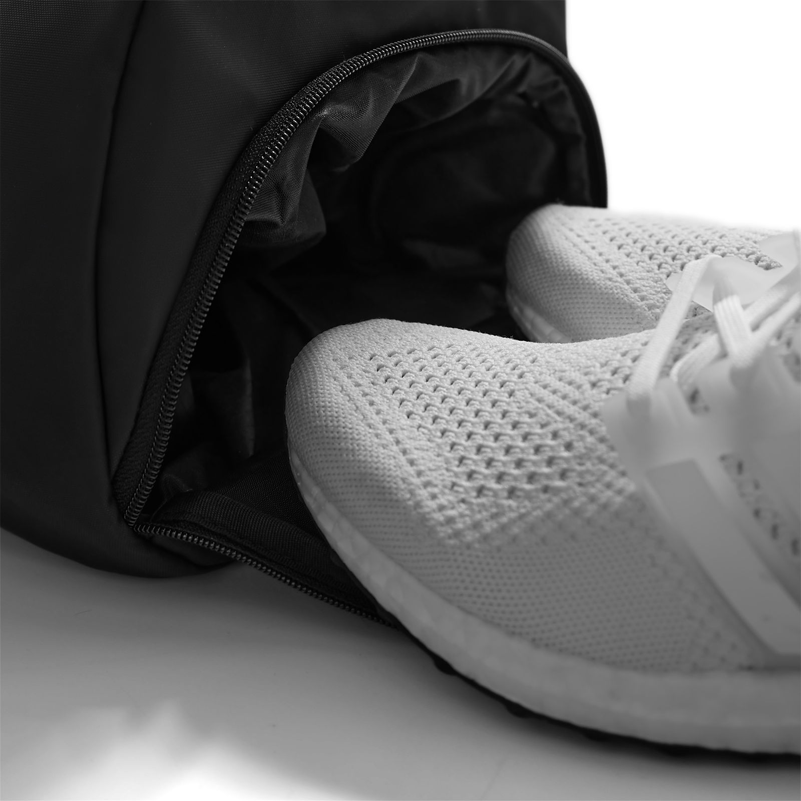 Barrel Gym Duffle Bag 30L in black with white sneakers, detail view