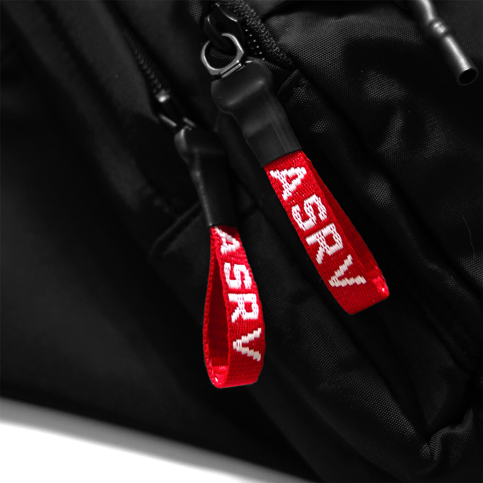 Flatlay of Large Waterproof Crossbody Bag in black with red zipper pulls