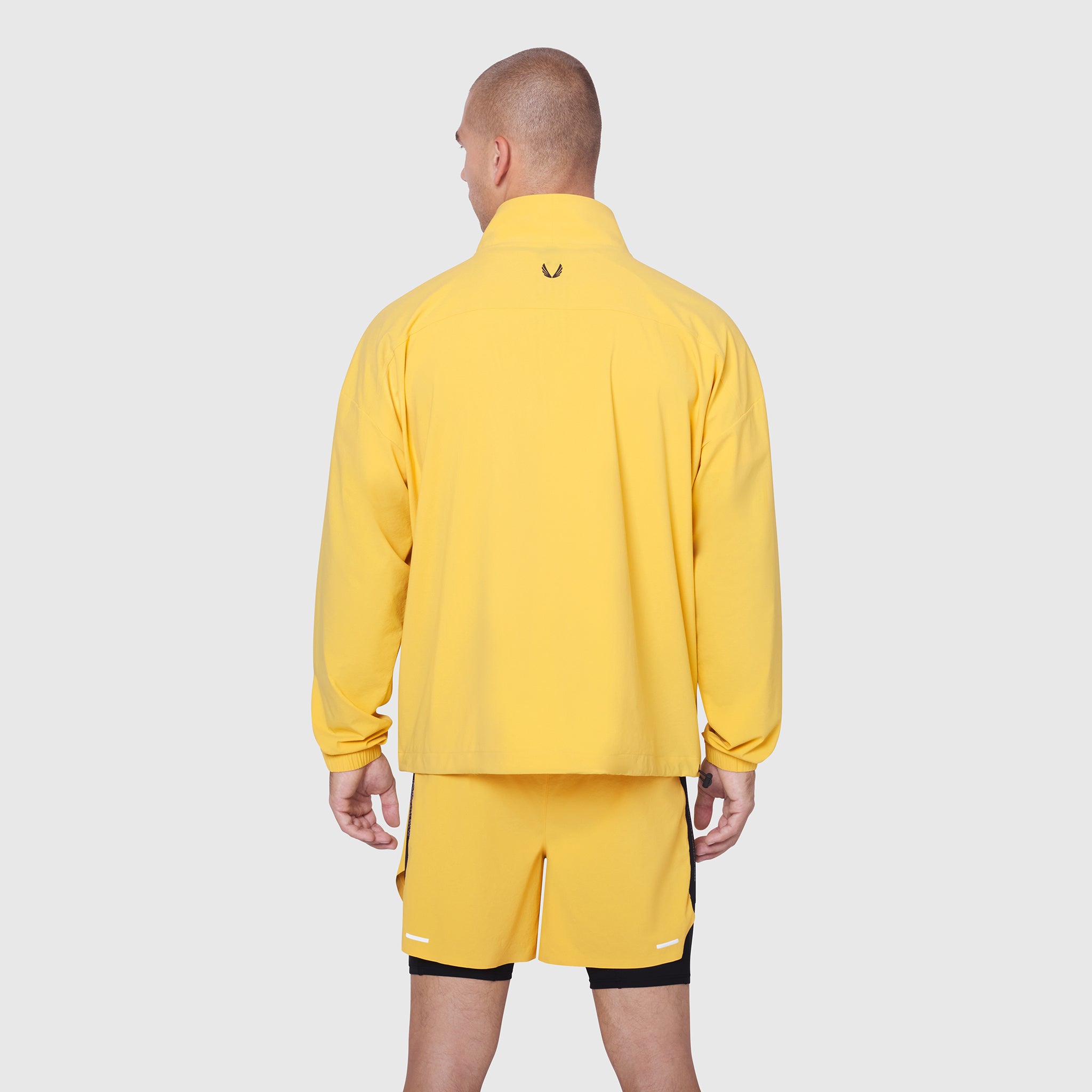 Aerotex Quarter-Zip Jacket in amber yellow worn by model, back view
