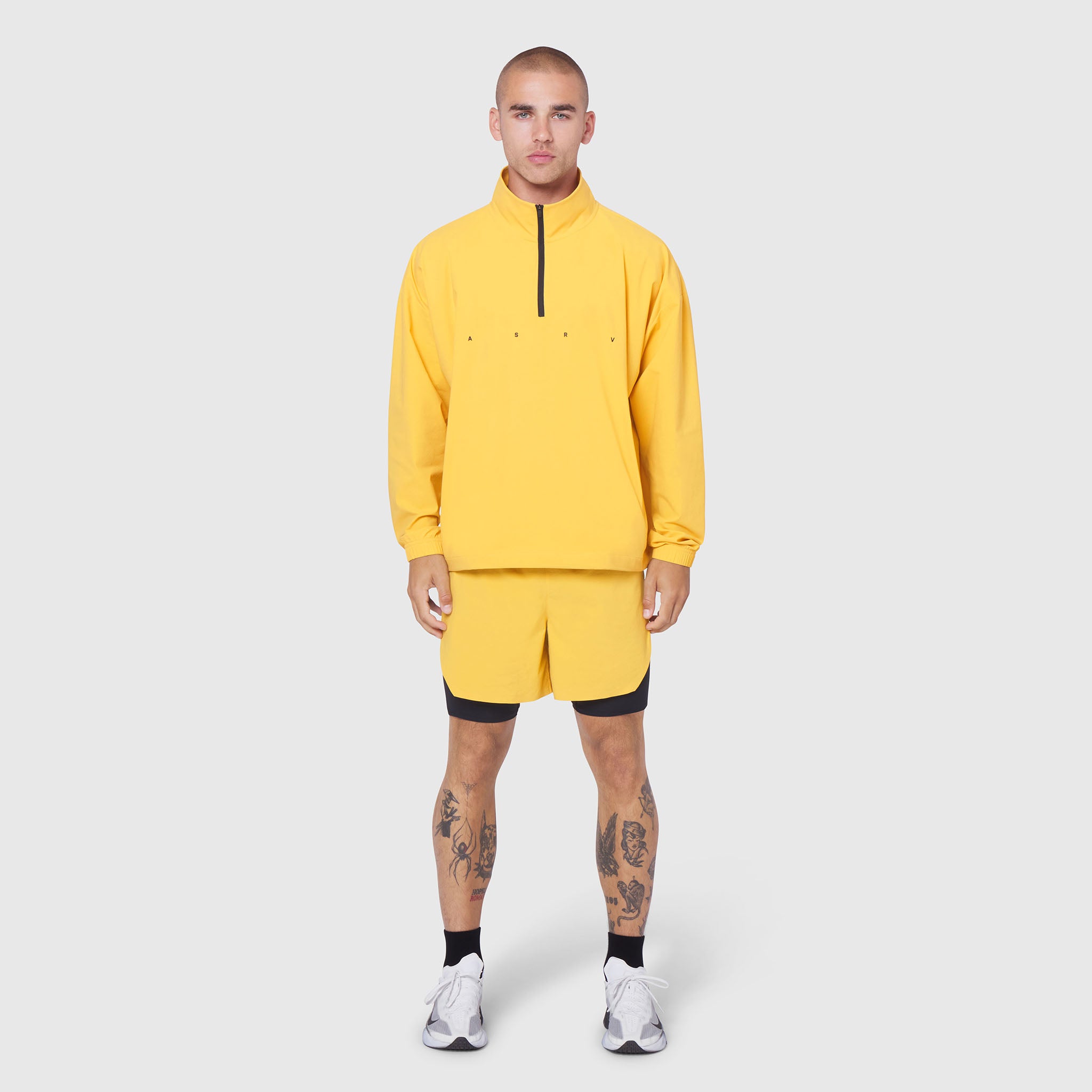 Aerotex Quarter-Zip Jacket in amber yellow with matching shorts, modeled standing front-facing