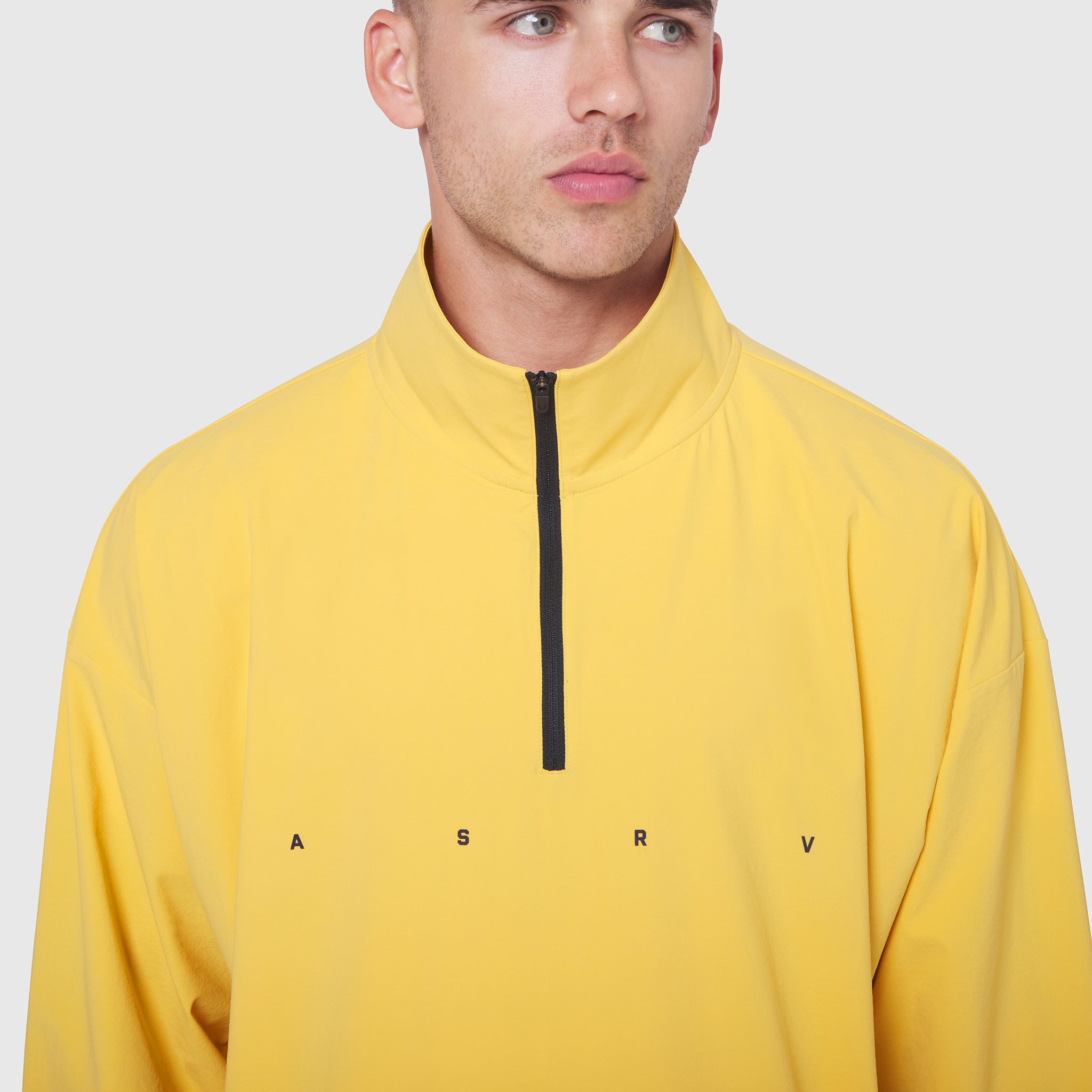 Aerotex Quarter-Zip Jacket in amber yellow worn by male model, front view