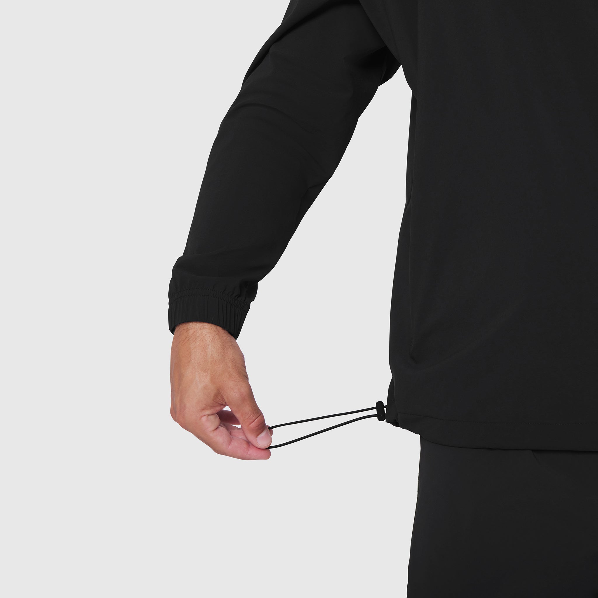 Aerotex Quarter-Zip Jacket in black, modeled with hand adjusting drawstring detail