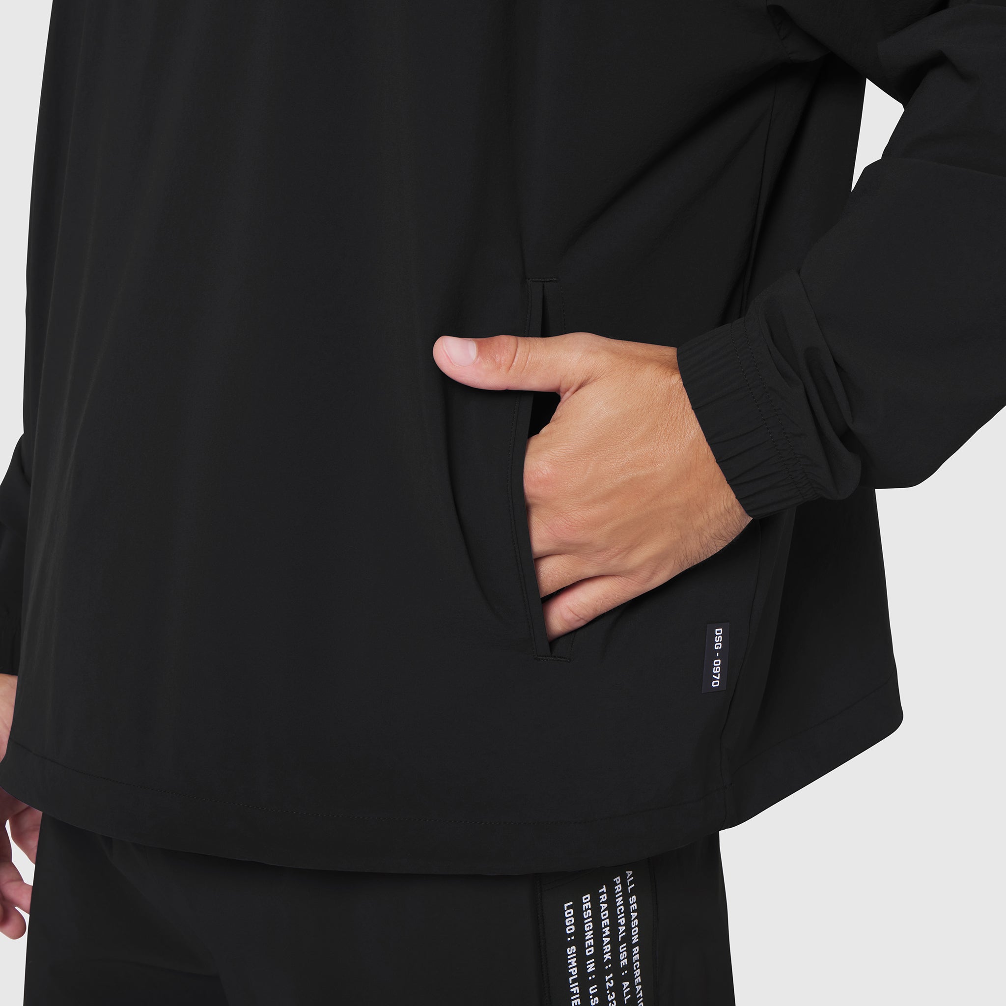 Black Aerotex Quarter-Zip Jacket worn by model with hand in pocket, front detail view