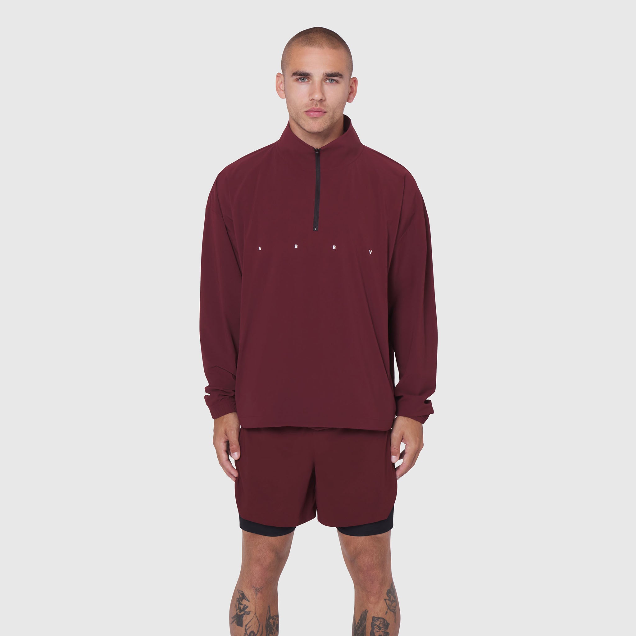 Aerotex Quarter-Zip Jacket in crimson worn with matching shorts, front view on model
