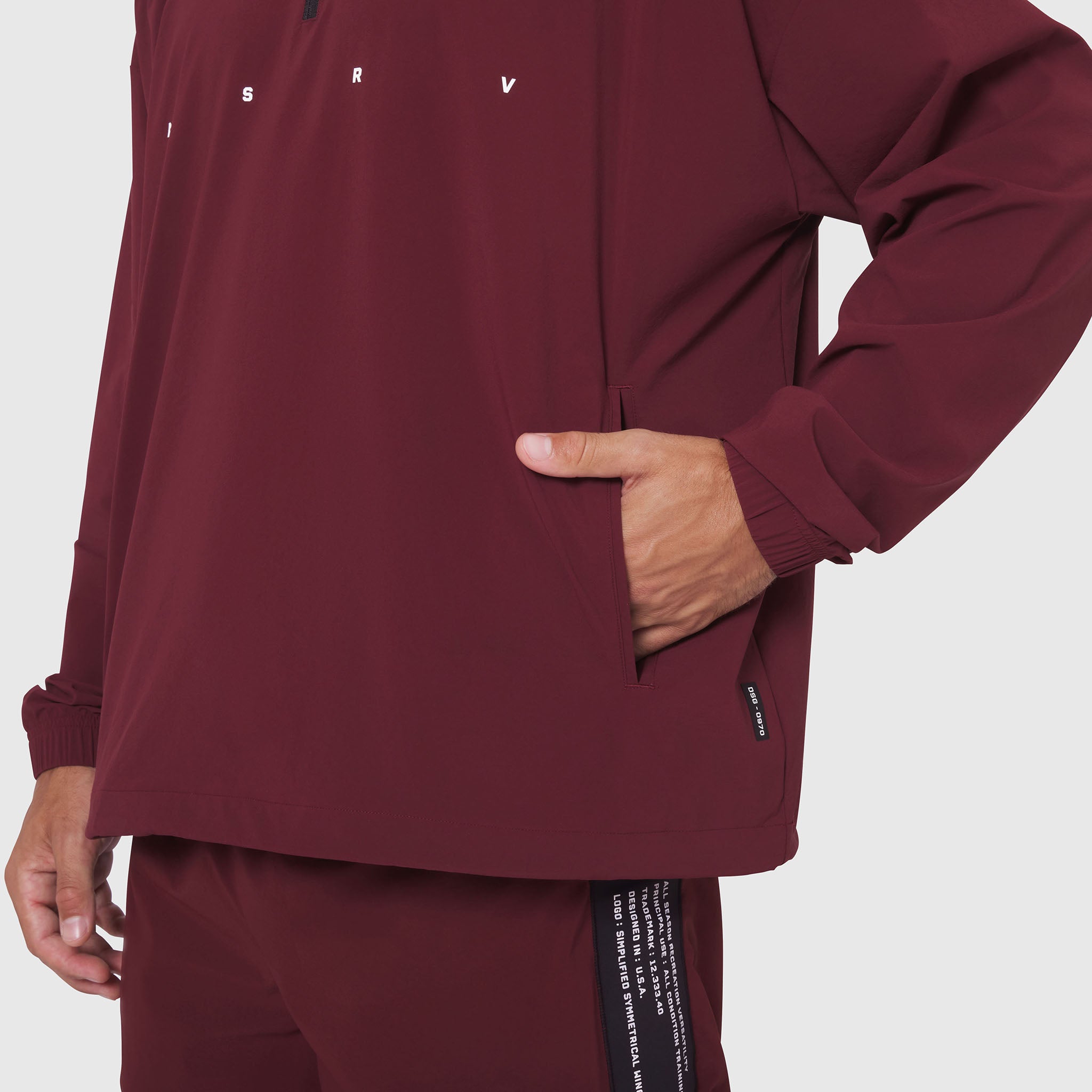 Aerotex Quarter-Zip Jacket in crimson worn by model, front view with hand in pocket