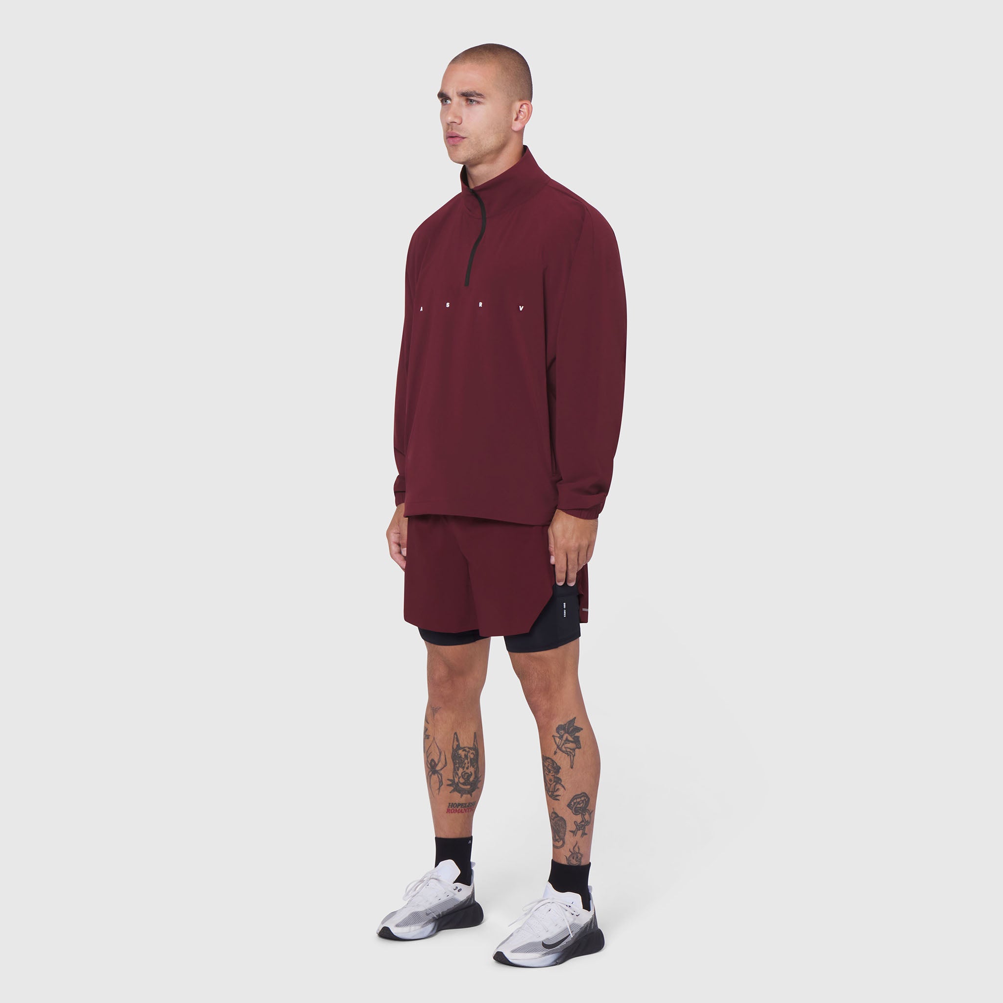 Aerotex Quarter-Zip Jacket in crimson worn by model with matching shorts, side view