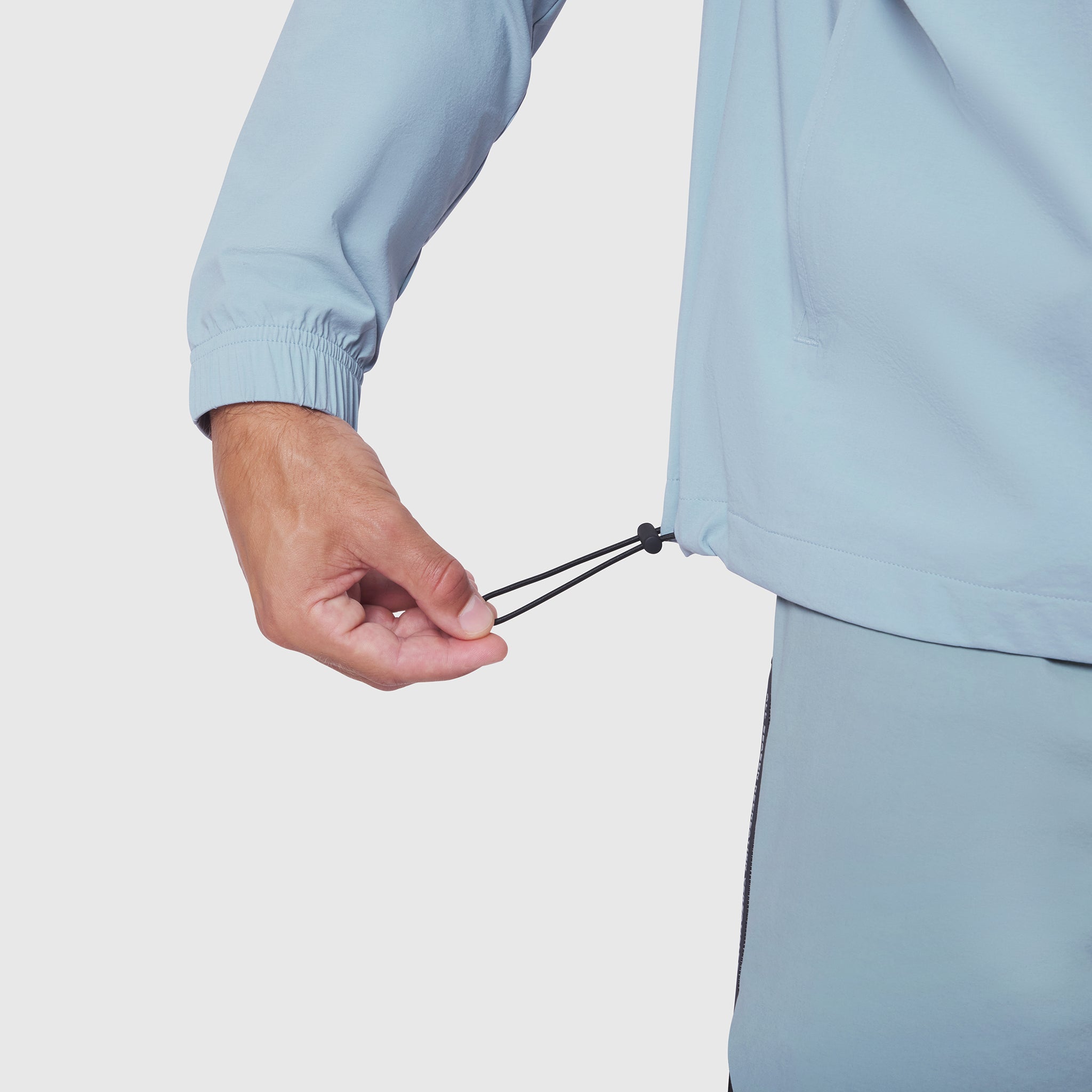 Aerotex Quarter-Zip Jacket in light sky, model wearing jacket with hand at zipper