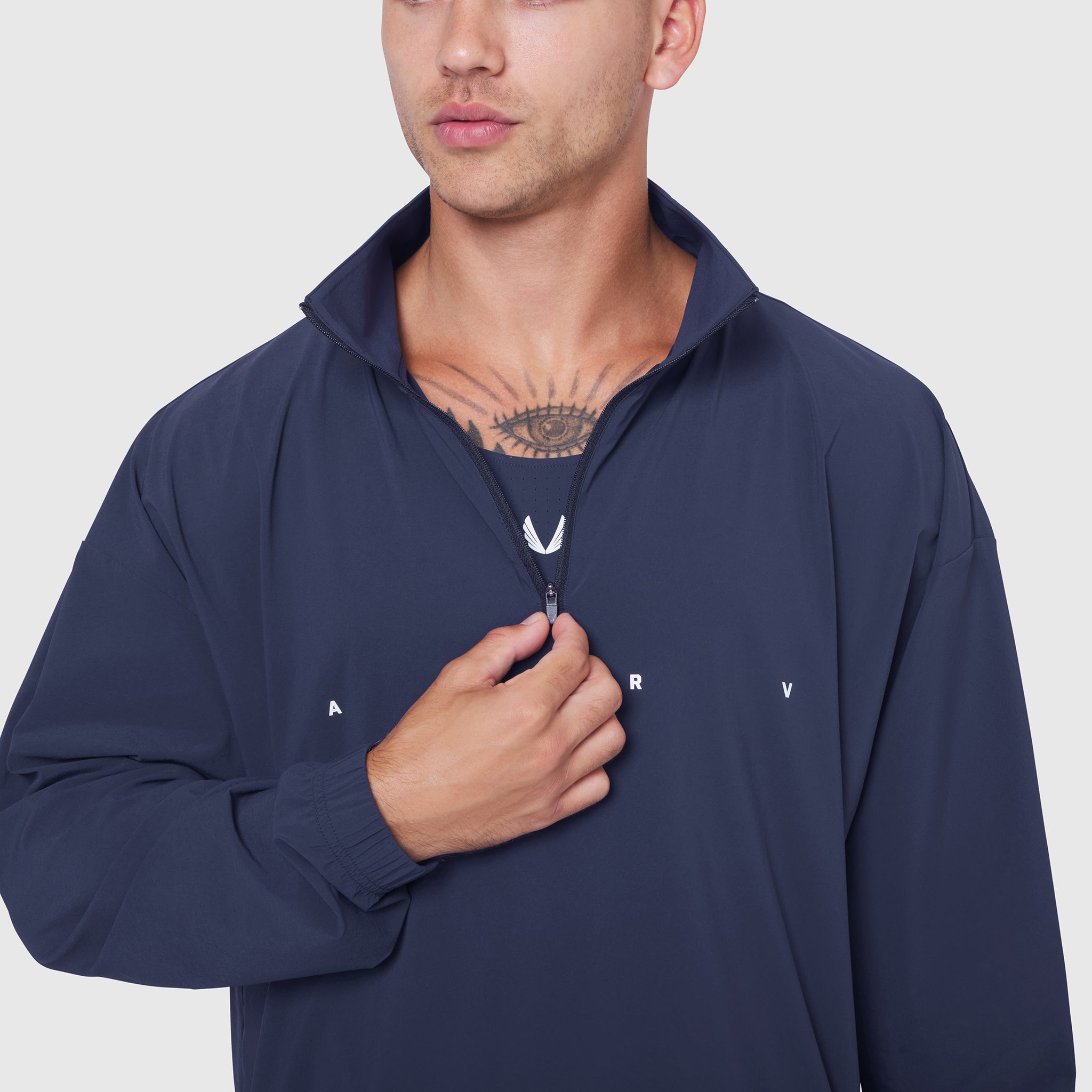 Aerotex Quarter-Zip Jacket in navy worn by male model, front view with hand on zipper