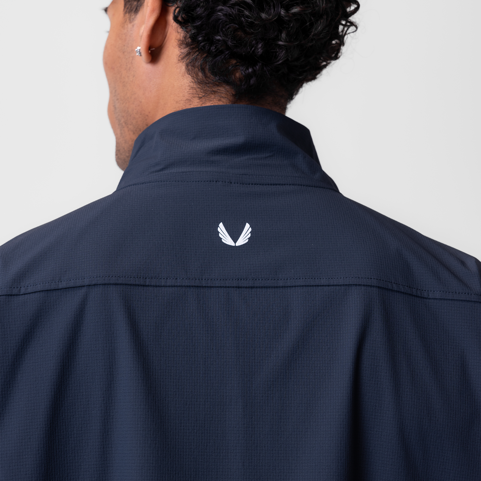Ripstop Quarter Zip Jacket in navy, back view on model showing branded logo