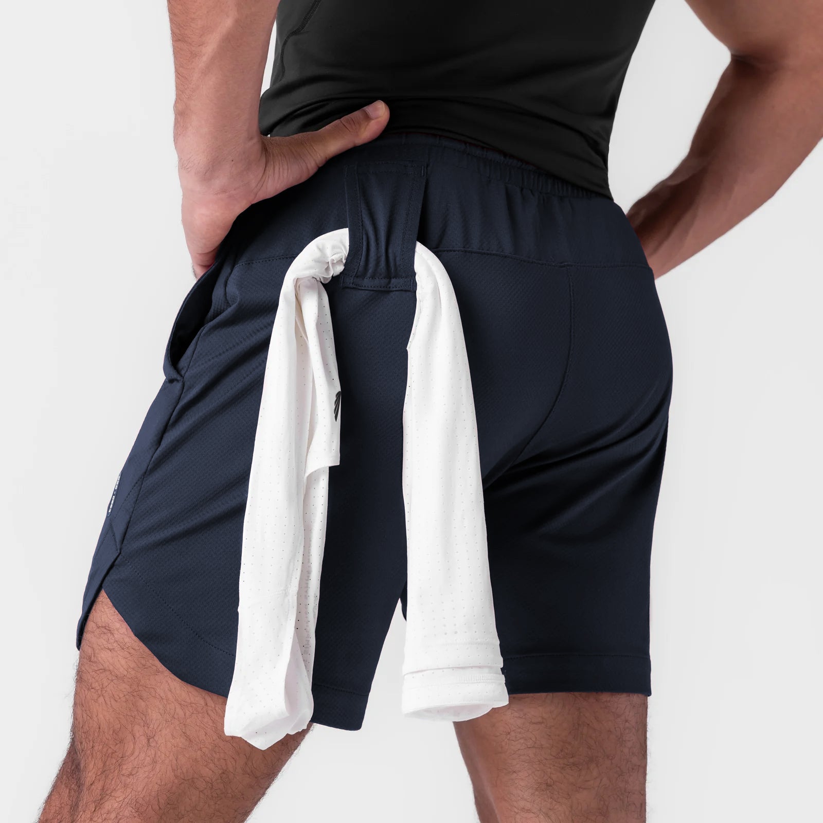 AeroSilver 7" Linerless Short in navy, worn by model with towel draped over shoulder, back view