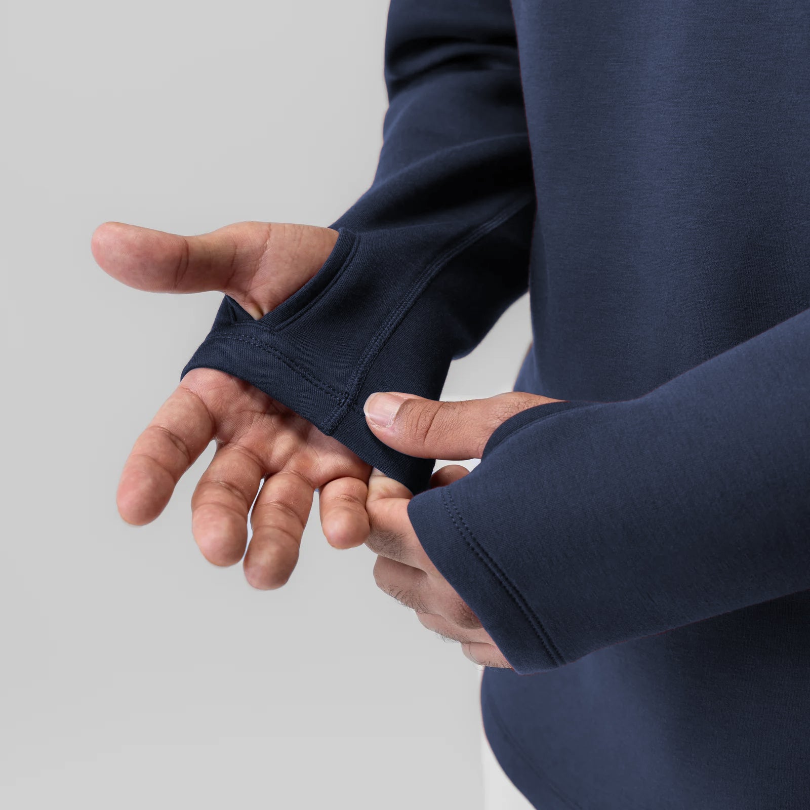 Dri-Core™ Zip Hoodie in navy worn by model, showing thumb hole detail on sleeve
