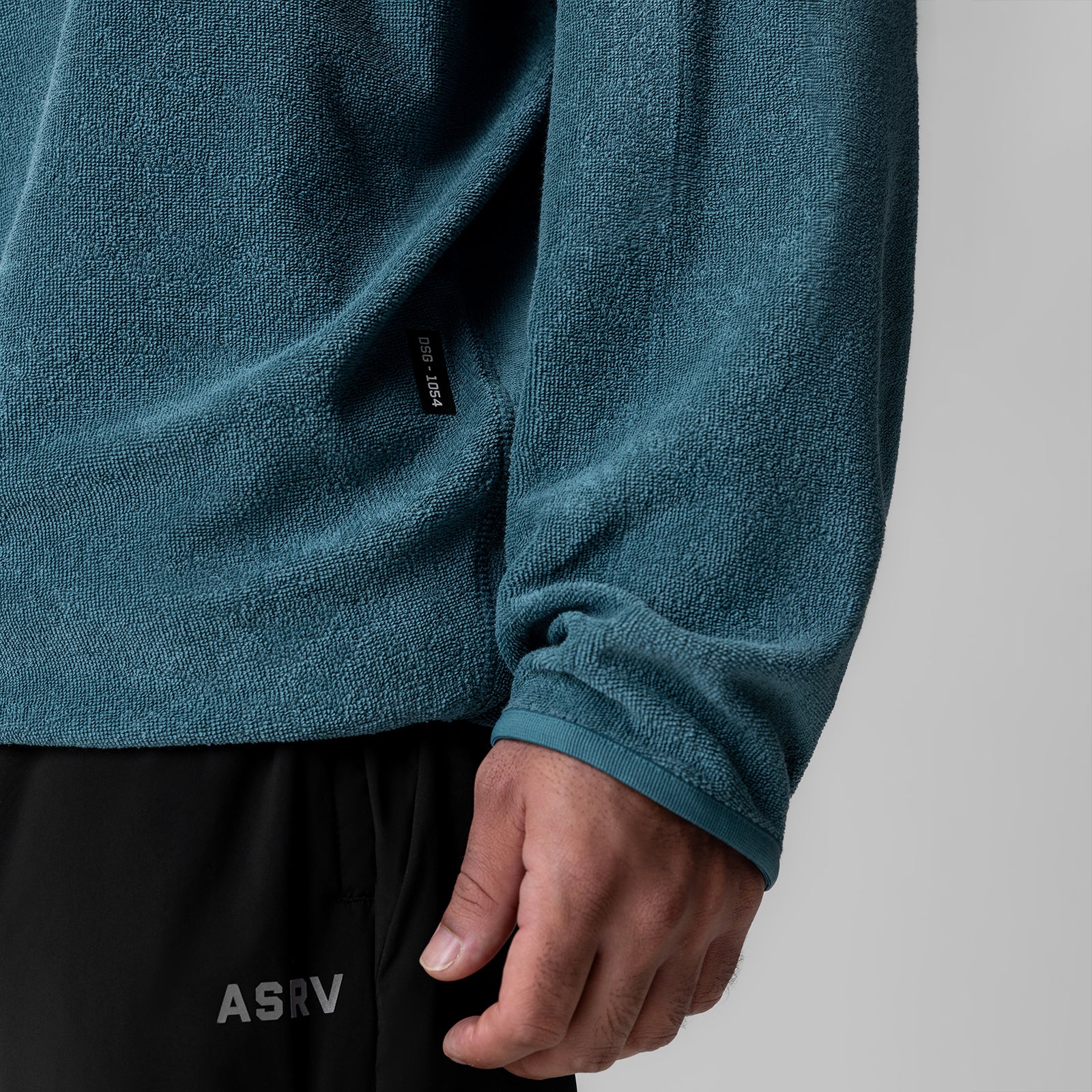 Towel Terry Reversible Hoodie in storm blue worn by model, close-up of sleeve and torso
