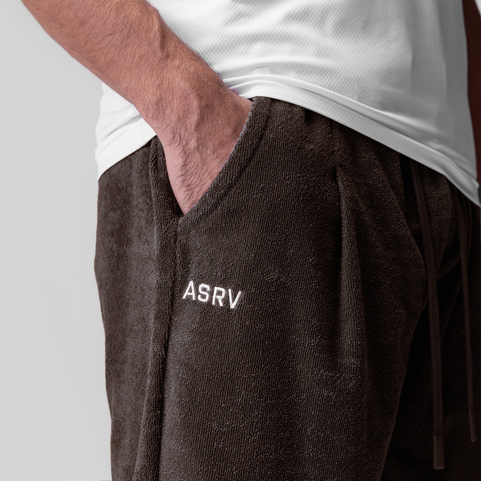 Towel Terry Relaxed Short in Dark Earth worn by model with hand in pocket, front view