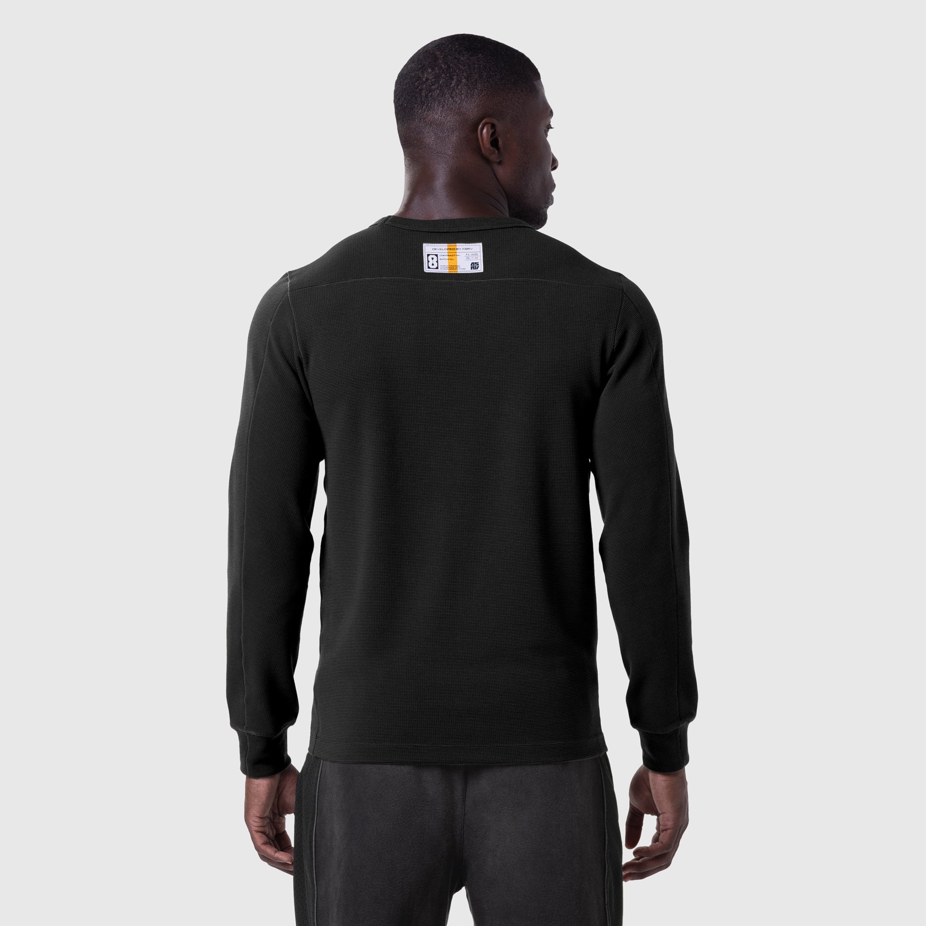 Black waffle knit longsleeve worn by model, back view