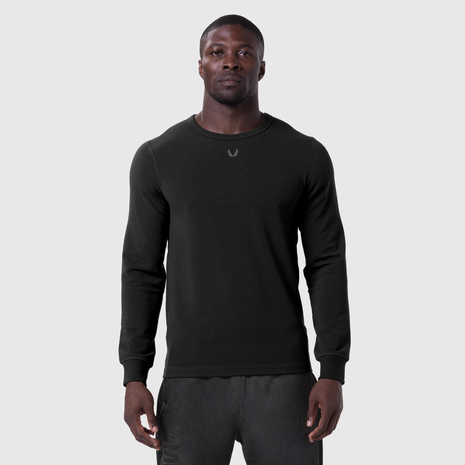 Black waffle knit longsleeve worn by model, front view