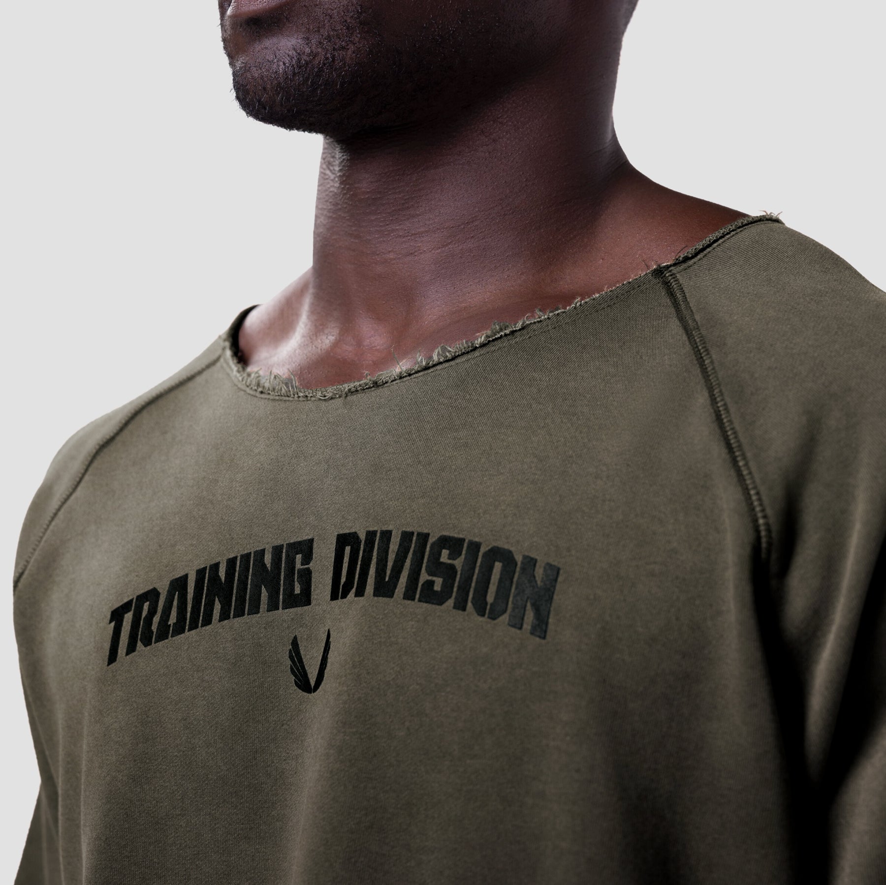 Vintage Raw Hem Pump Cover in olive, worn by model showing chest graphic detail