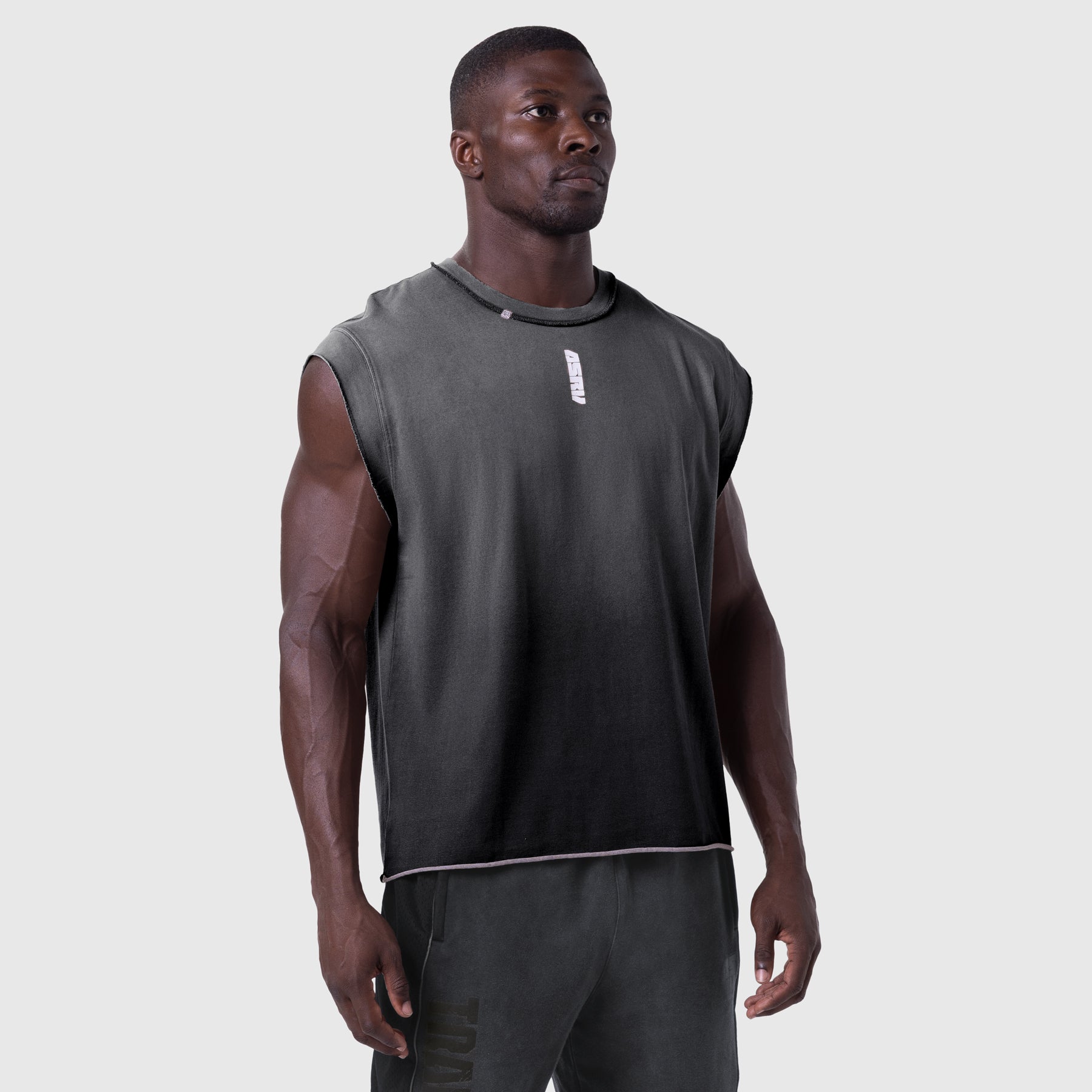 Tech Essential Cap Shoulder Cutoff tank in black sun fade, worn by model, front view