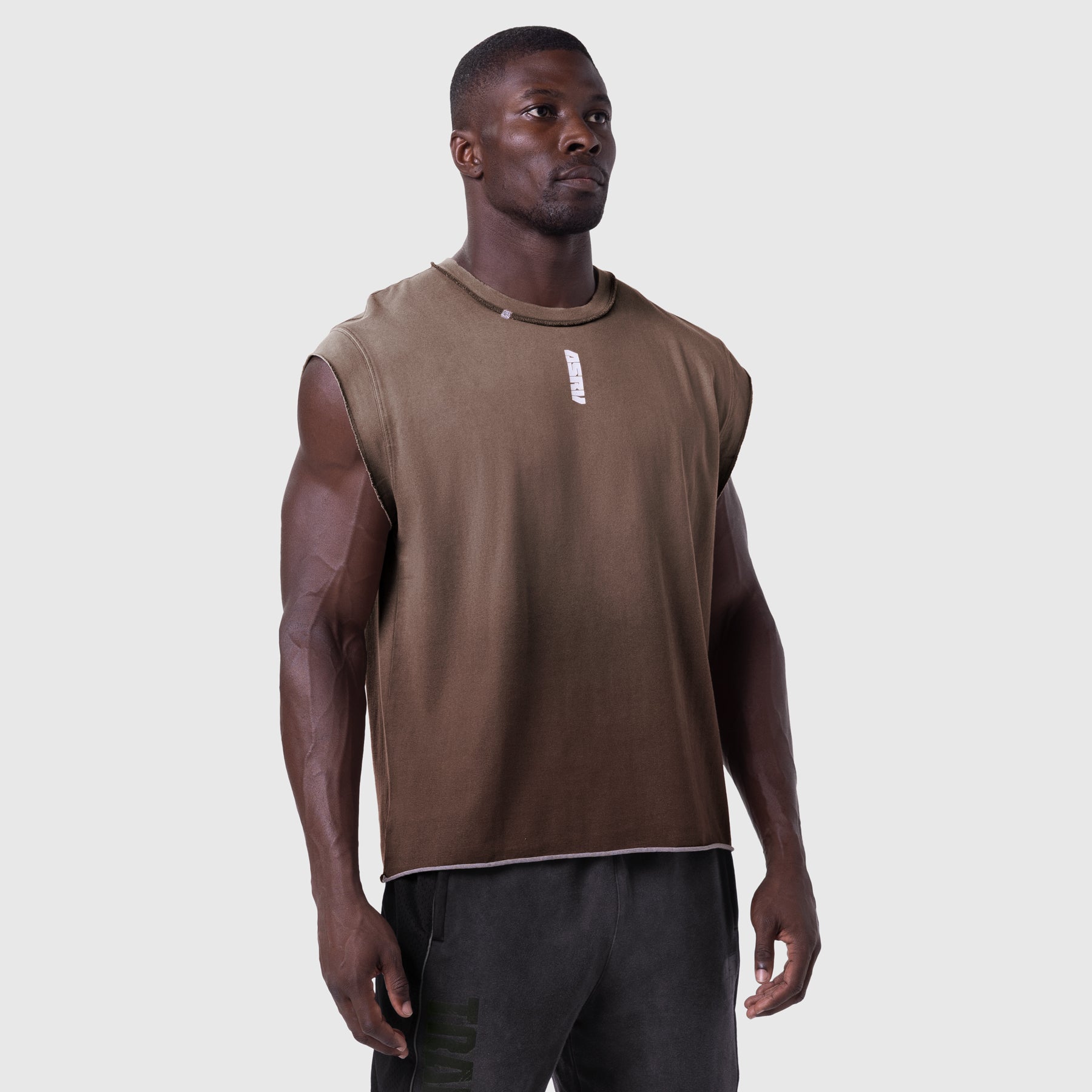 Tech Essential Cap Shoulder Cutoff sleeveless tank in dark earth, worn by model, front view
