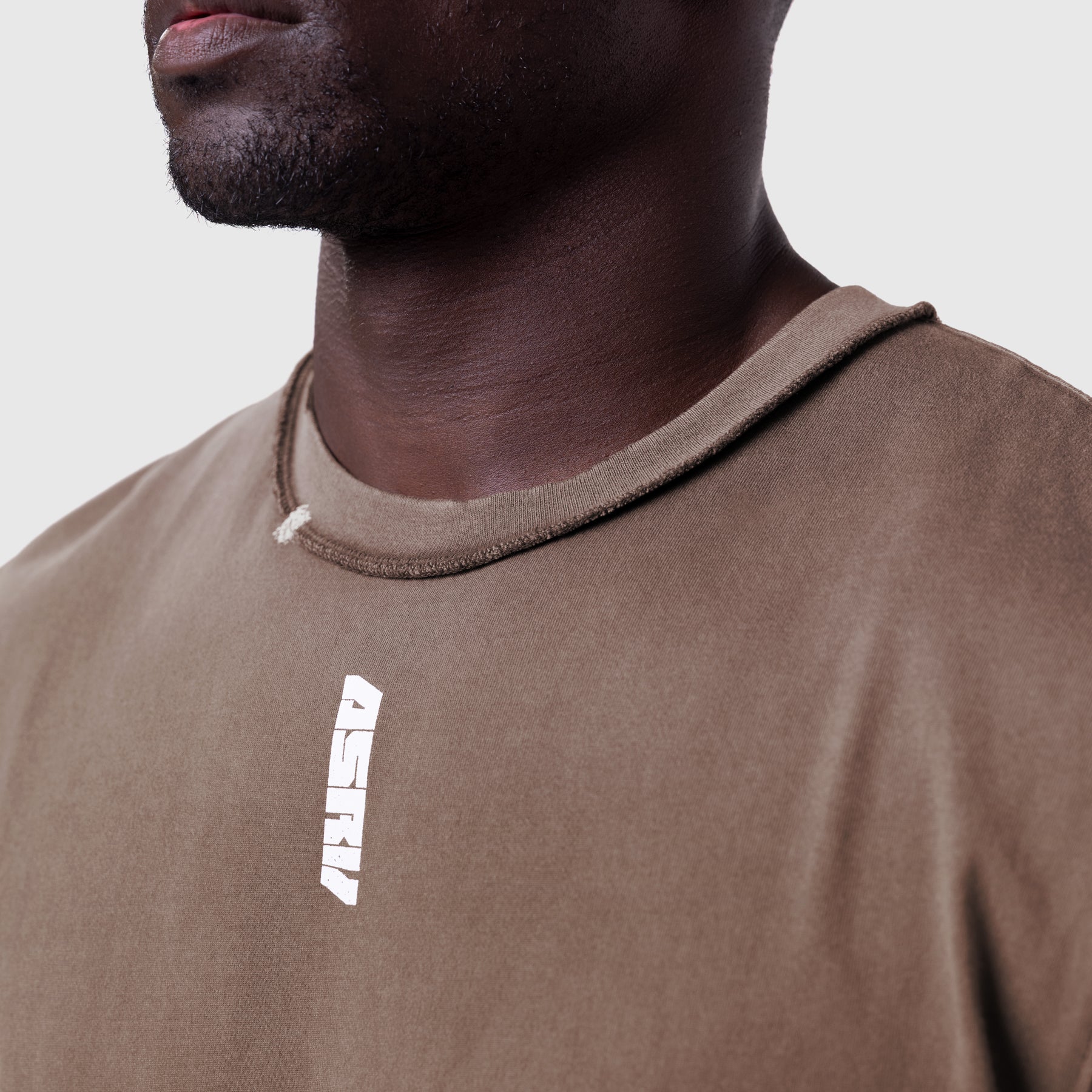 Tech Essential Cap Shoulder Cutoff in dark earth, worn by model, front detail view