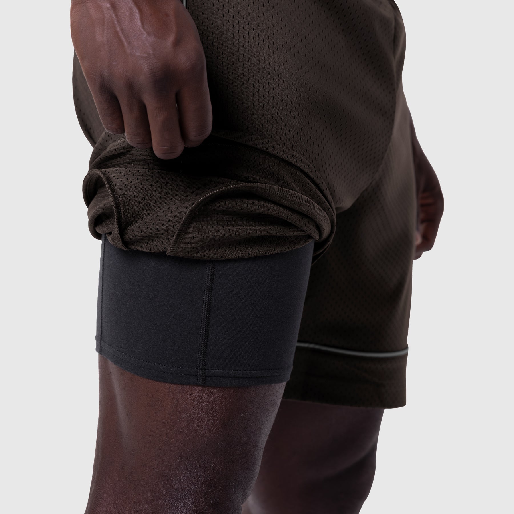 Ion-Mesh™ Modal Liner Short in Dark Earth being held up to show mesh fabric detail