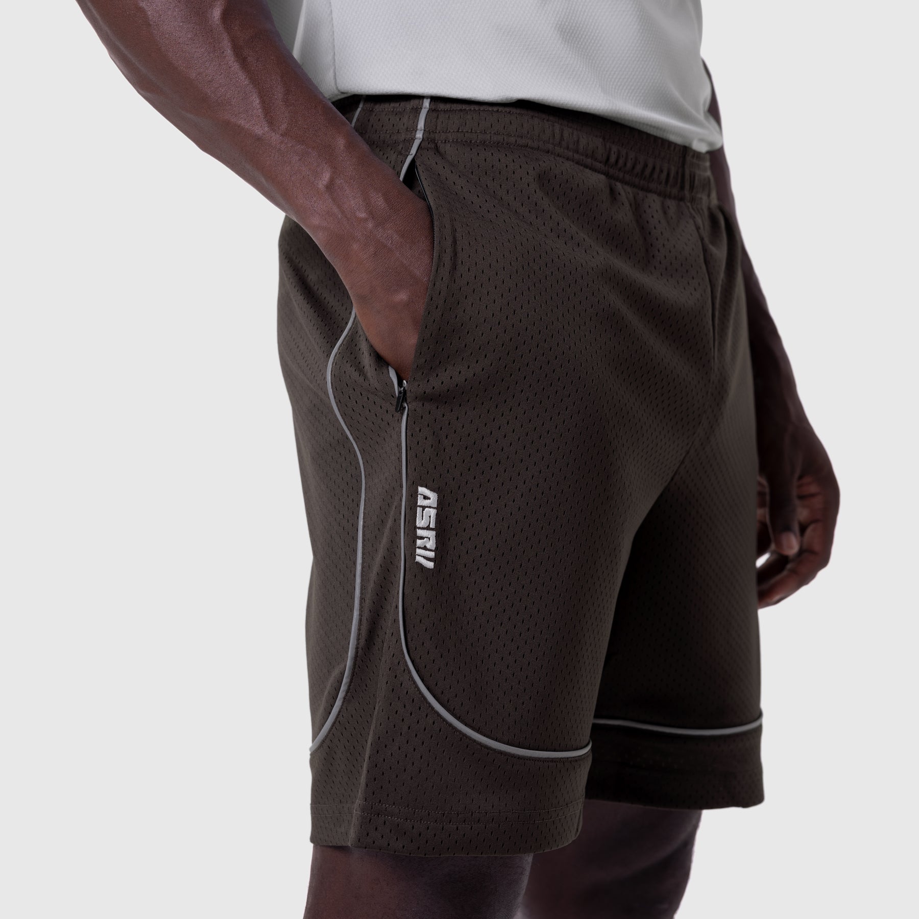 Ion-Mesh Modal Liner Short in Dark Earth, worn by model with hand in pocket, side view