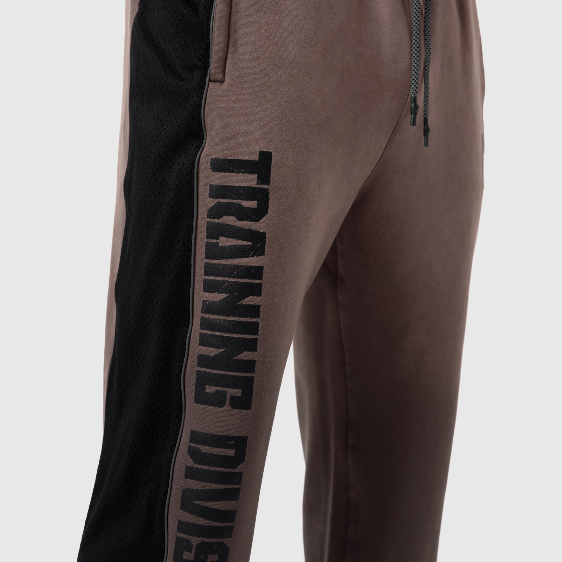 Tech-Terry Mesh Panel Sweats in dark earth with black mesh panels, worn on model, side view