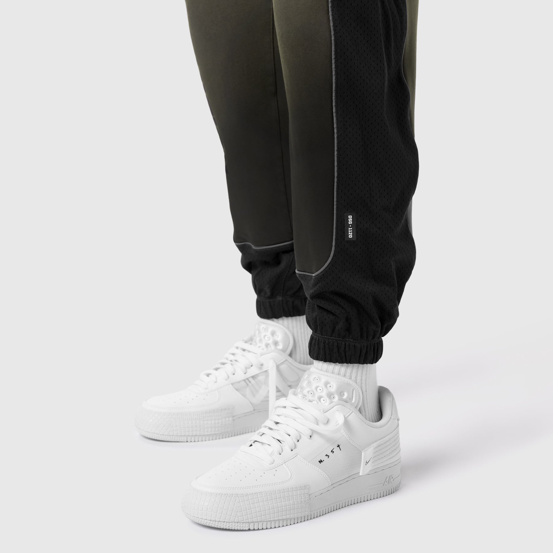 Tech-Terry Mesh Panel Sweats in olive worn with white sneakers and white socks, lower body view