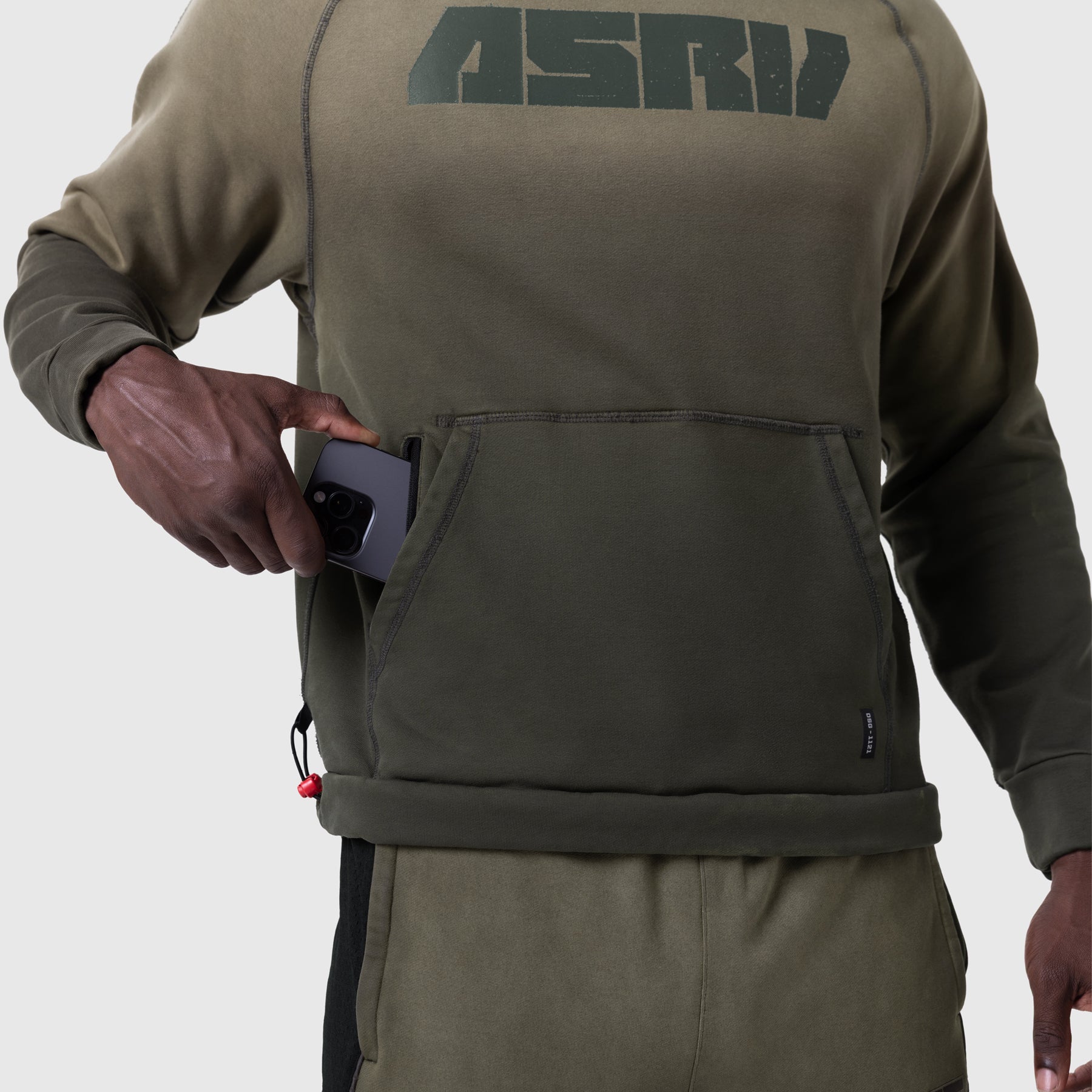 Tech-Terry Training Hoodie in olive, worn by model holding phone in front pocket