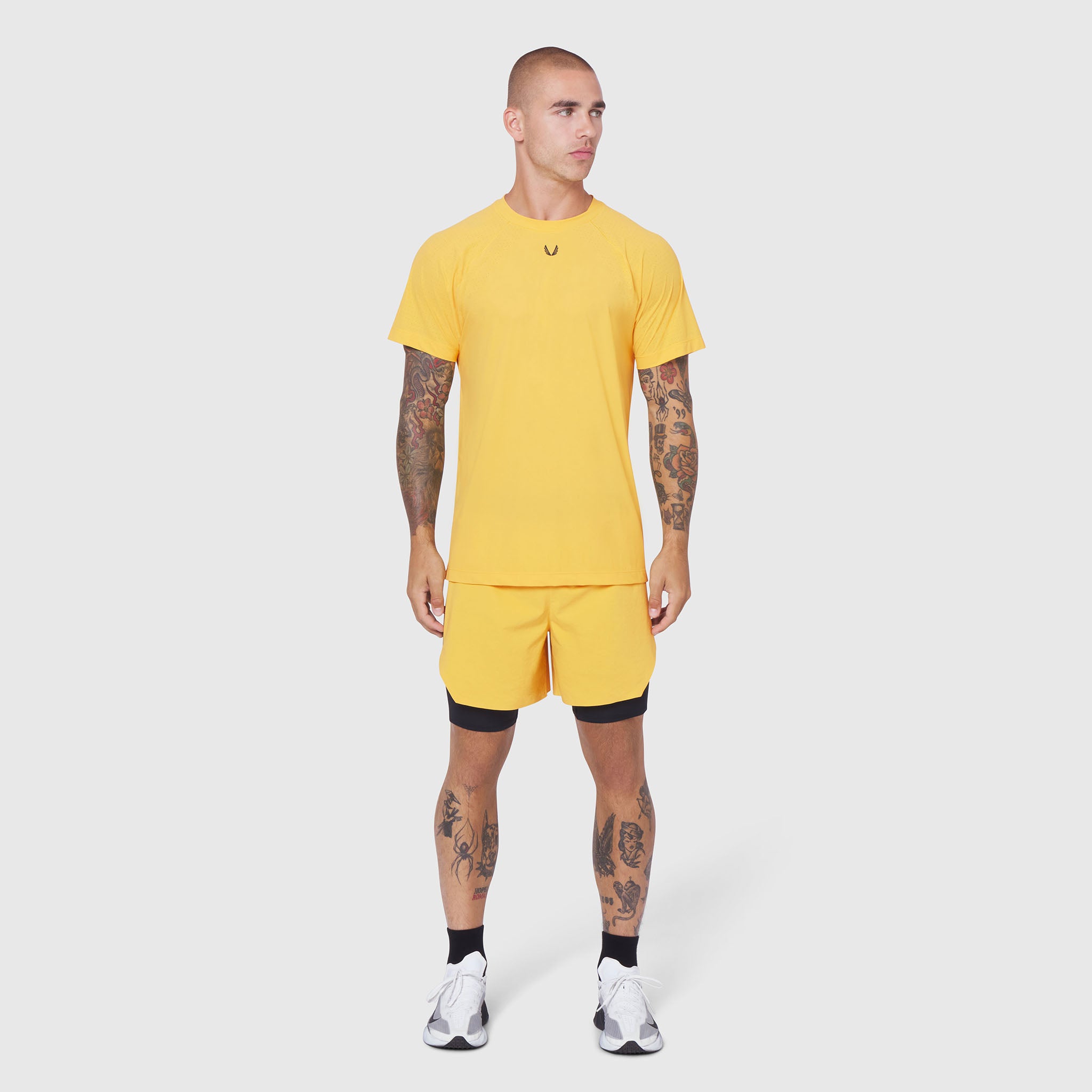 Laser-Vent Training Tee in amber yellow with matching shorts, front view on model