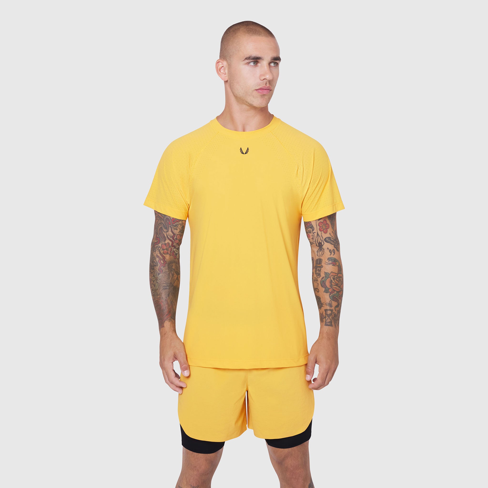 Laser-Vent™ Training Tee in amber yellow worn with matching shorts, front view on model