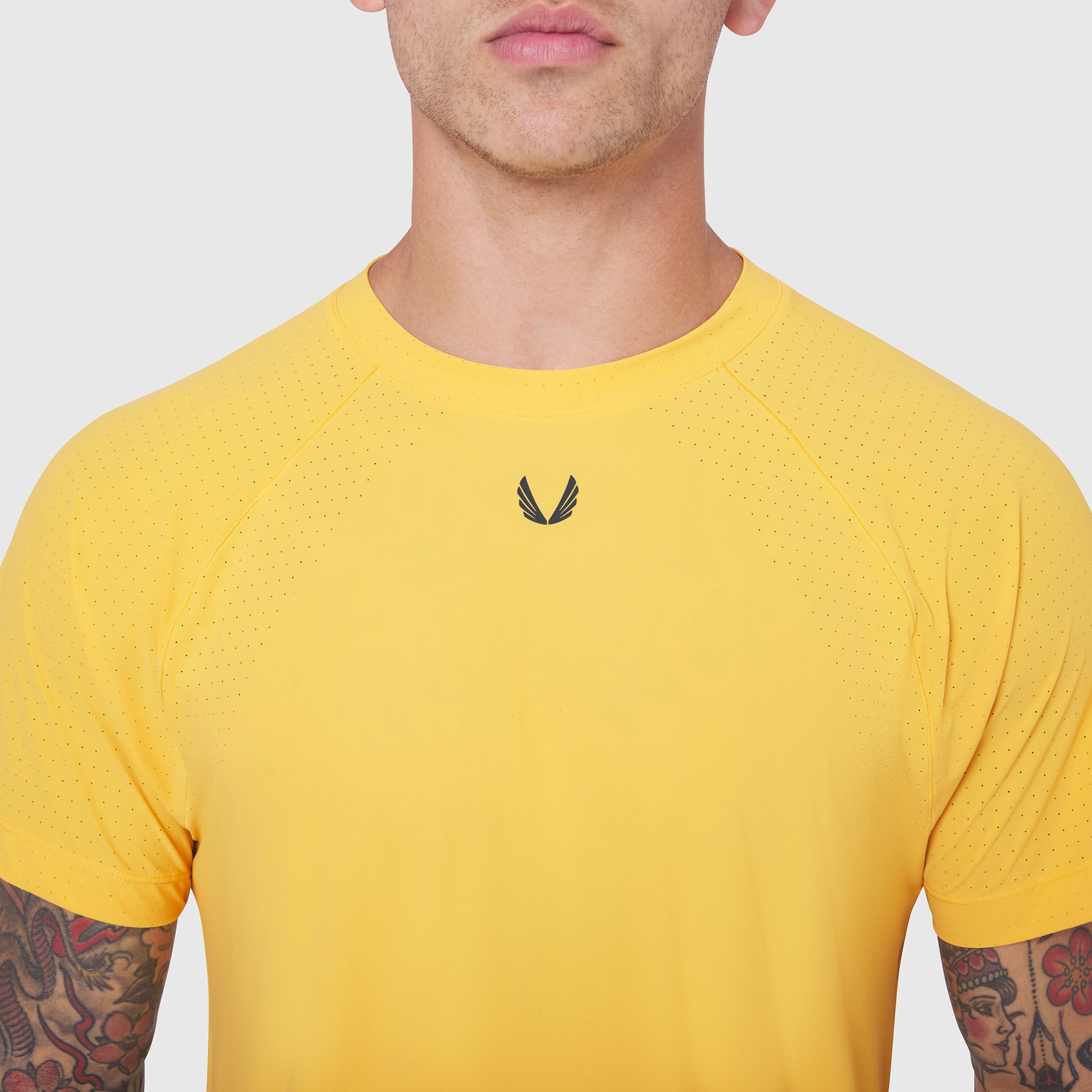 Laser-Vent Training Tee in Amber yellow worn by model, front view