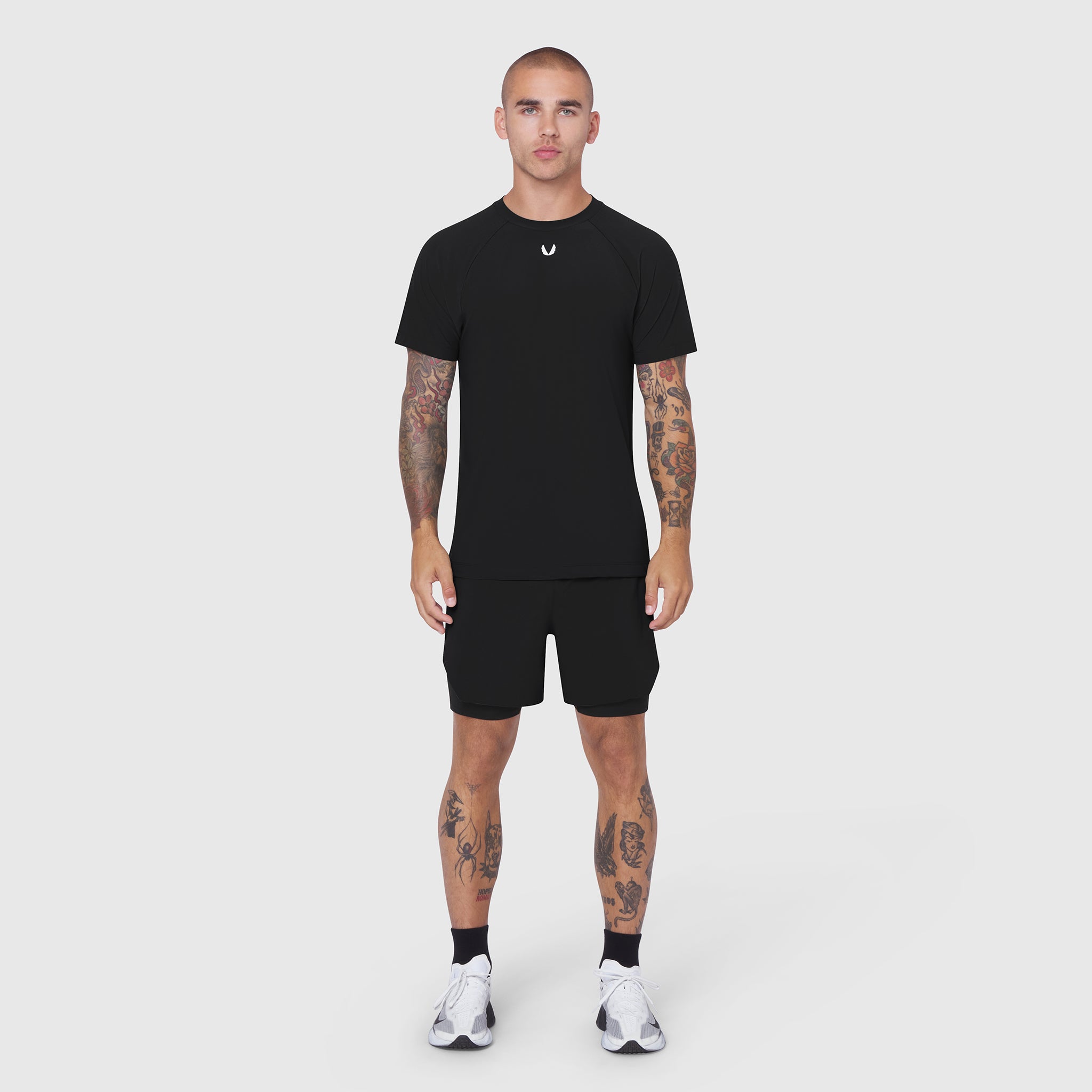 Black Laser-Vent Training Tee worn with black shorts, front view on model