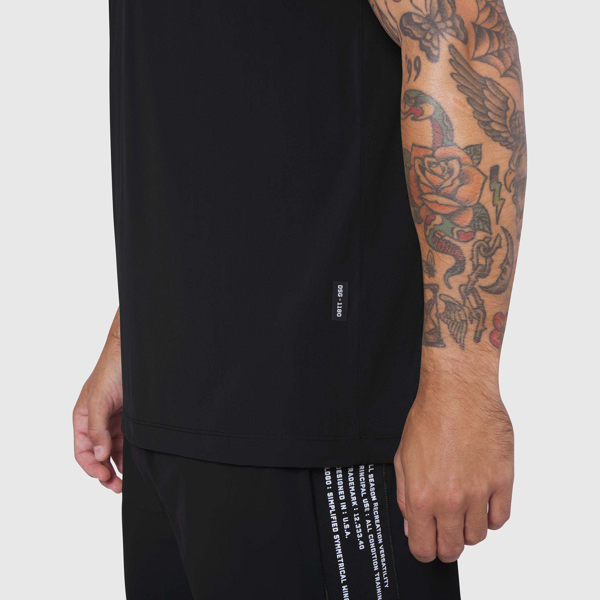 Laser-Vent™ Training Tee in black worn by model, side view showing sleeve and torso
