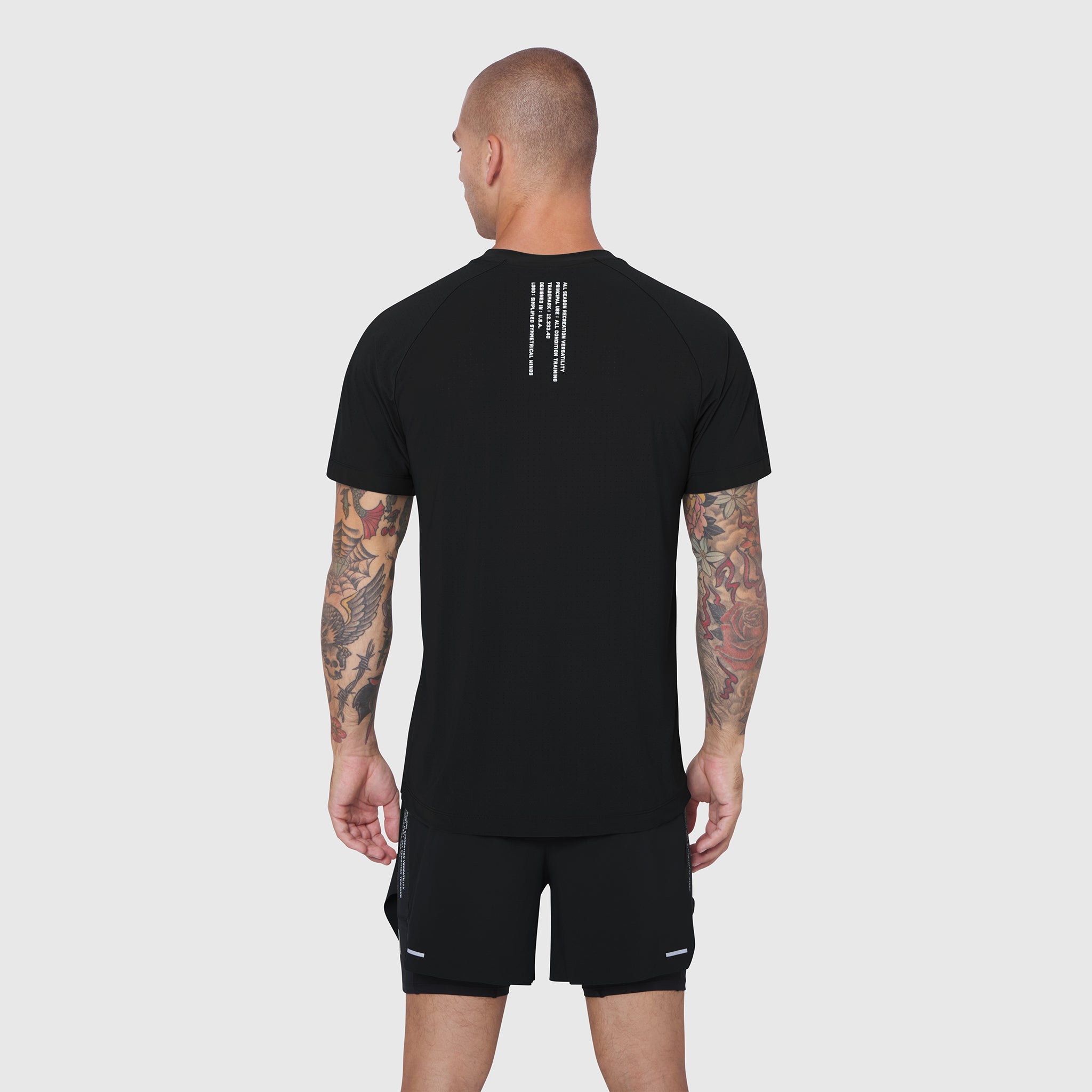 Black Laser-Vent Training Tee worn by model, back view showing rear design detail