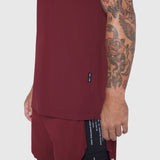 Laser-Vent Training Tee in Crimson worn by model showing side view with tattoo visible