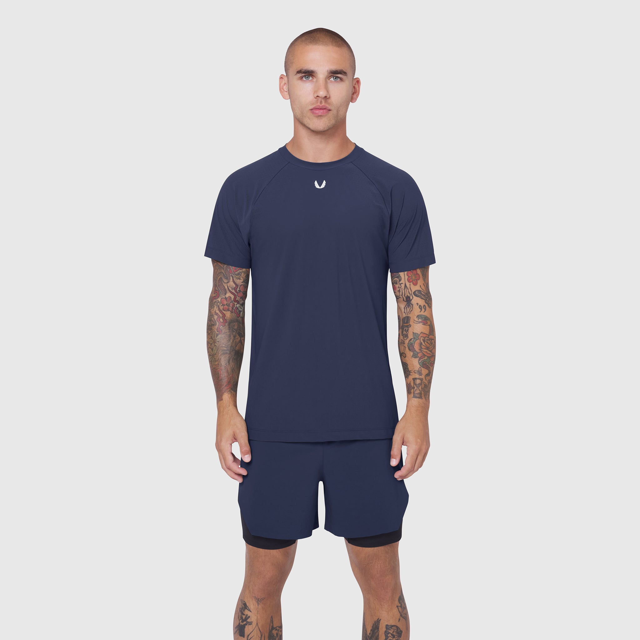 Laser-Vent™ Training Tee in navy worn by model with matching shorts, front view