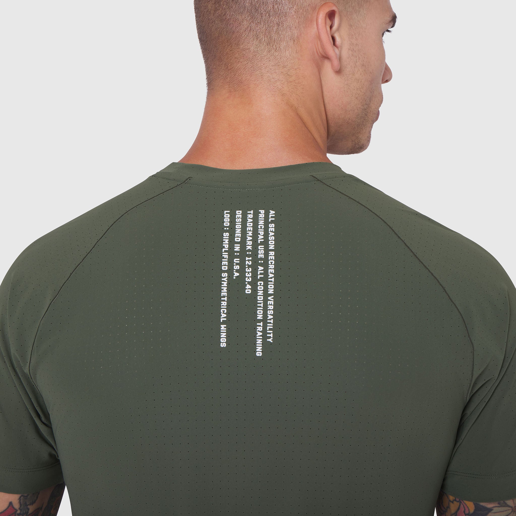 Laser-Vent™ Training Tee in olive worn by model, back view showing text detail