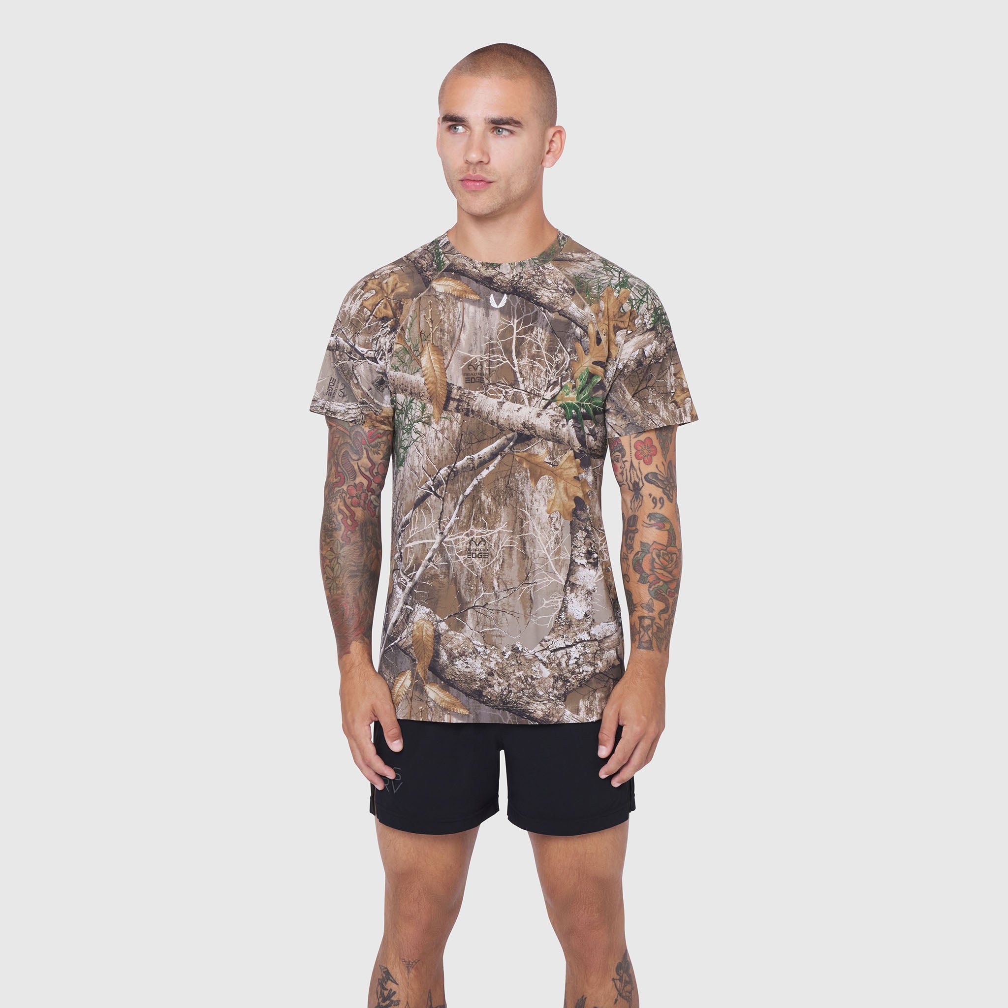 Laser-Vent Training Tee in Realtree Edge camo, worn by model with black shorts