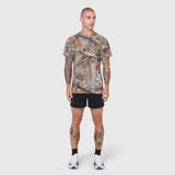 Laser-Vent Training Tee in Realtree Edge camo, worn with black shorts, front view on model