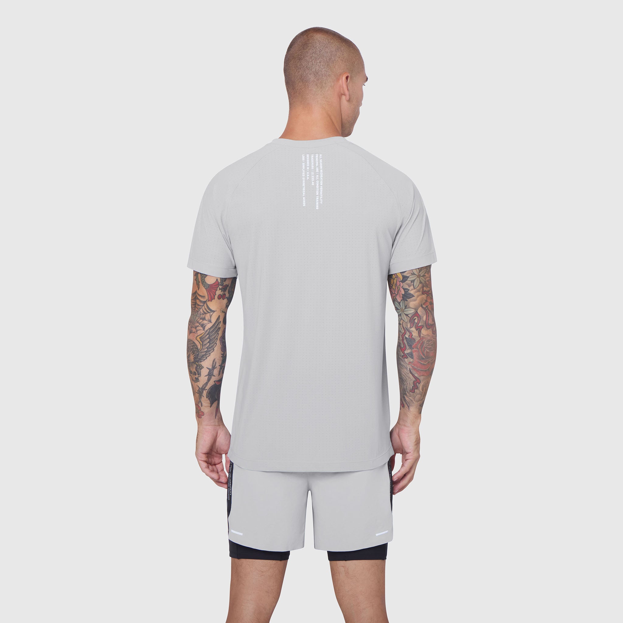 Laser-Vent Training Tee in slate grey, back view on model with tattoos
