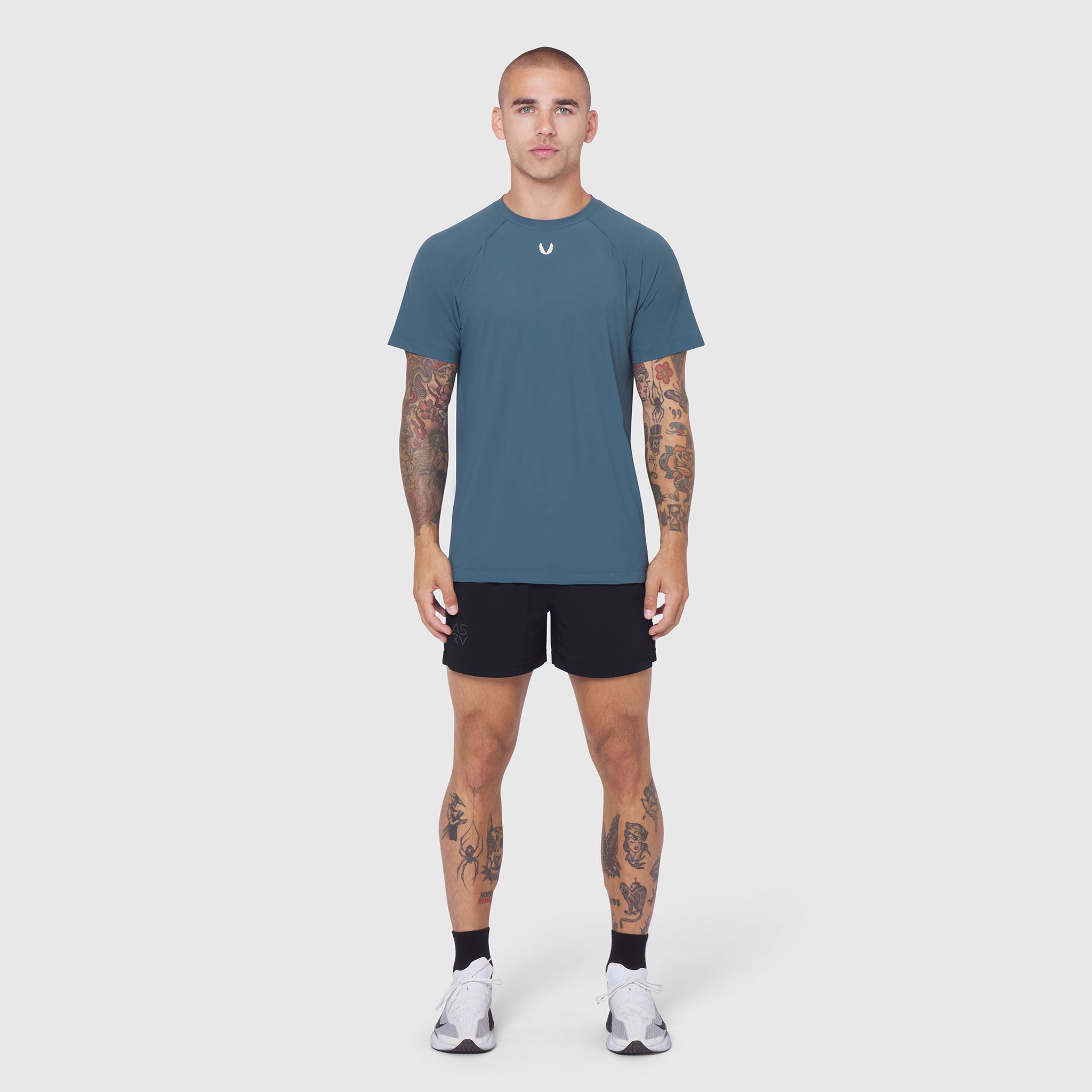 Laser-Vent Training Tee in storm blue worn with black shorts, front view on model
