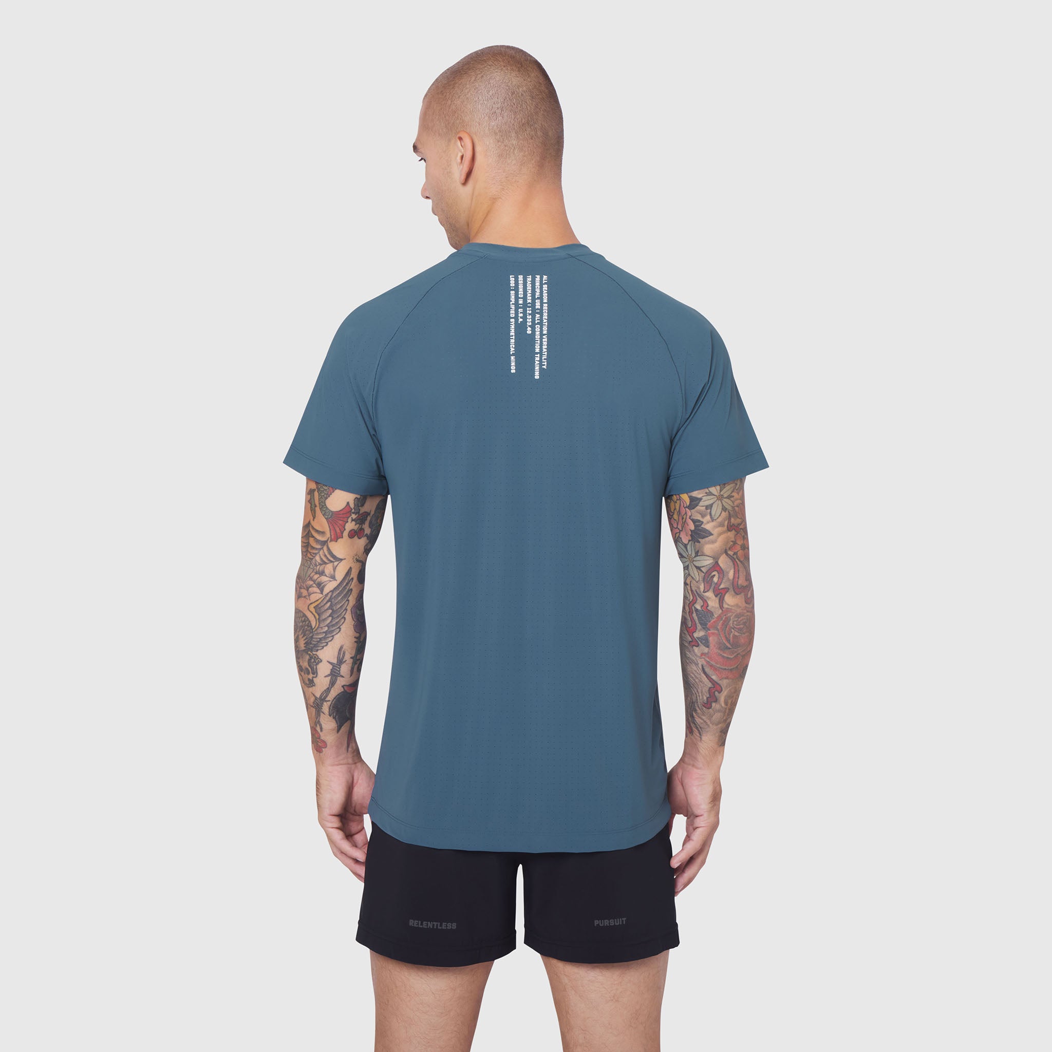 Laser-Vent Training Tee in storm blue, worn by model from back view showing text detail