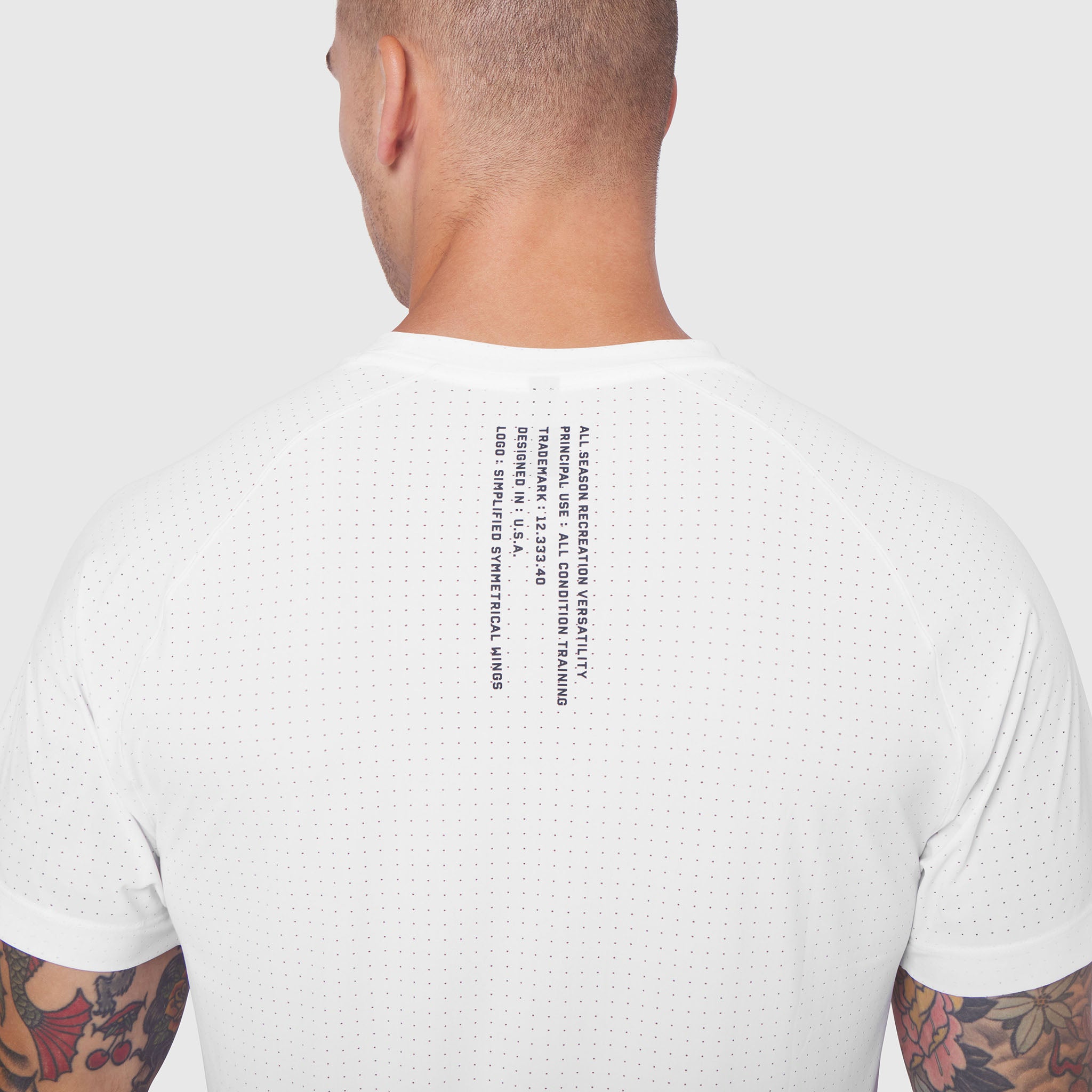 Laser-Vent™ Training Tee in white worn by model, back view showing text detail