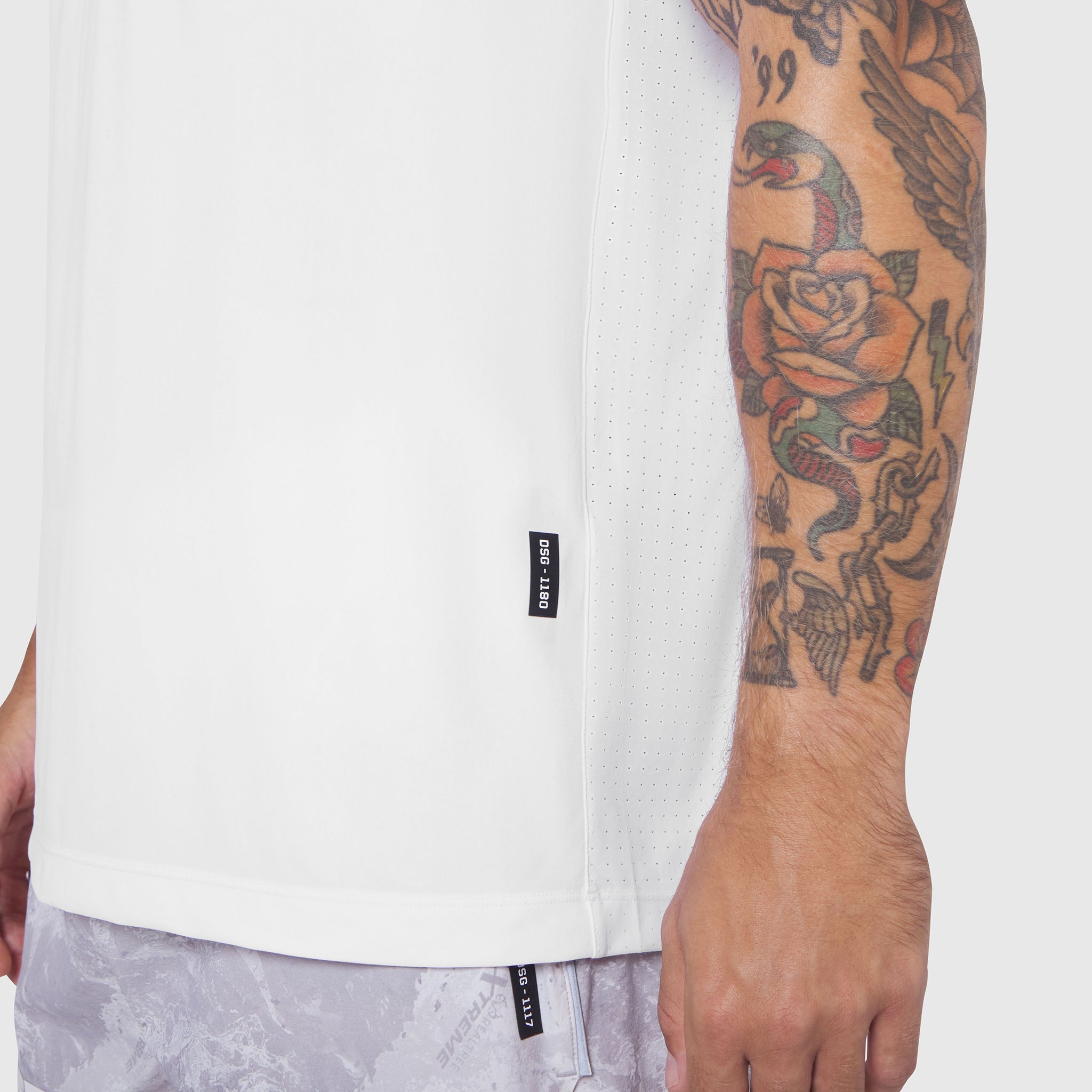 White Laser-Vent Training Tee worn by model showing side view, highlighting perforated fabric detail