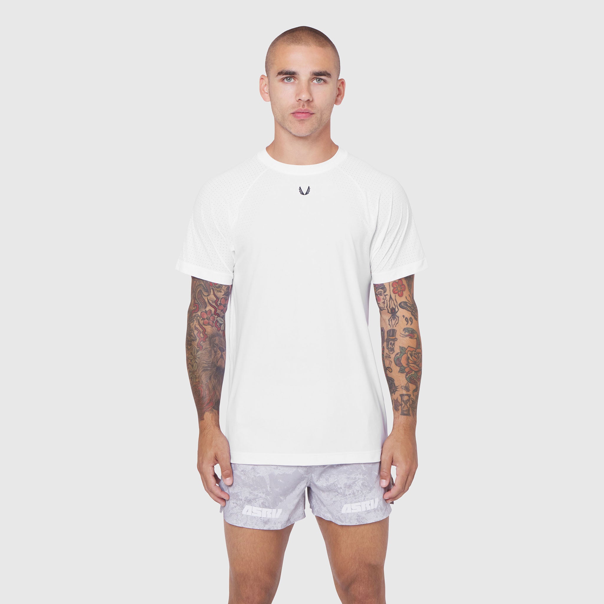 White Laser-Vent Training Tee worn by male model with lavender shorts, front view