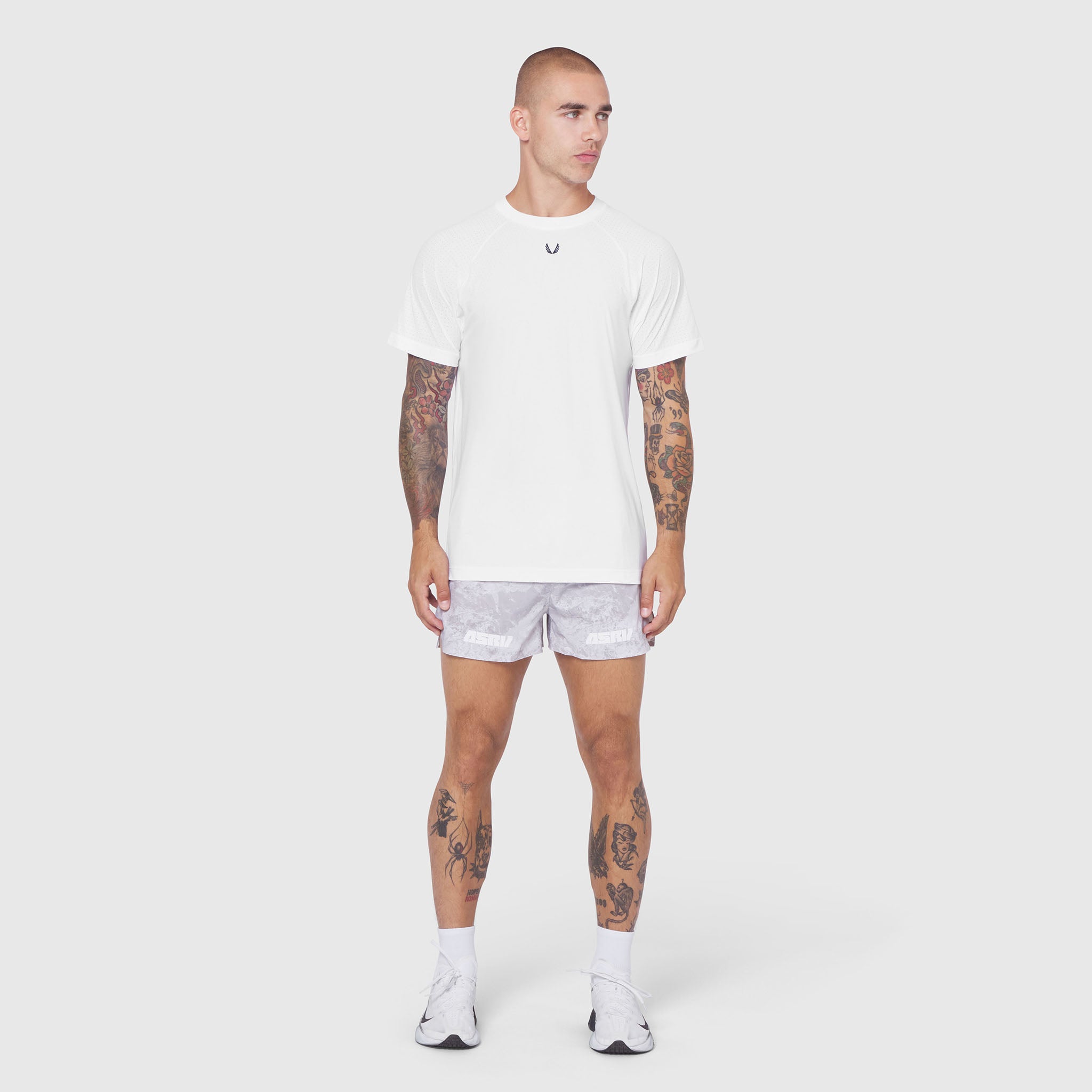 Laser-Vent™ Training Tee in white, worn by male model with shorts, front view