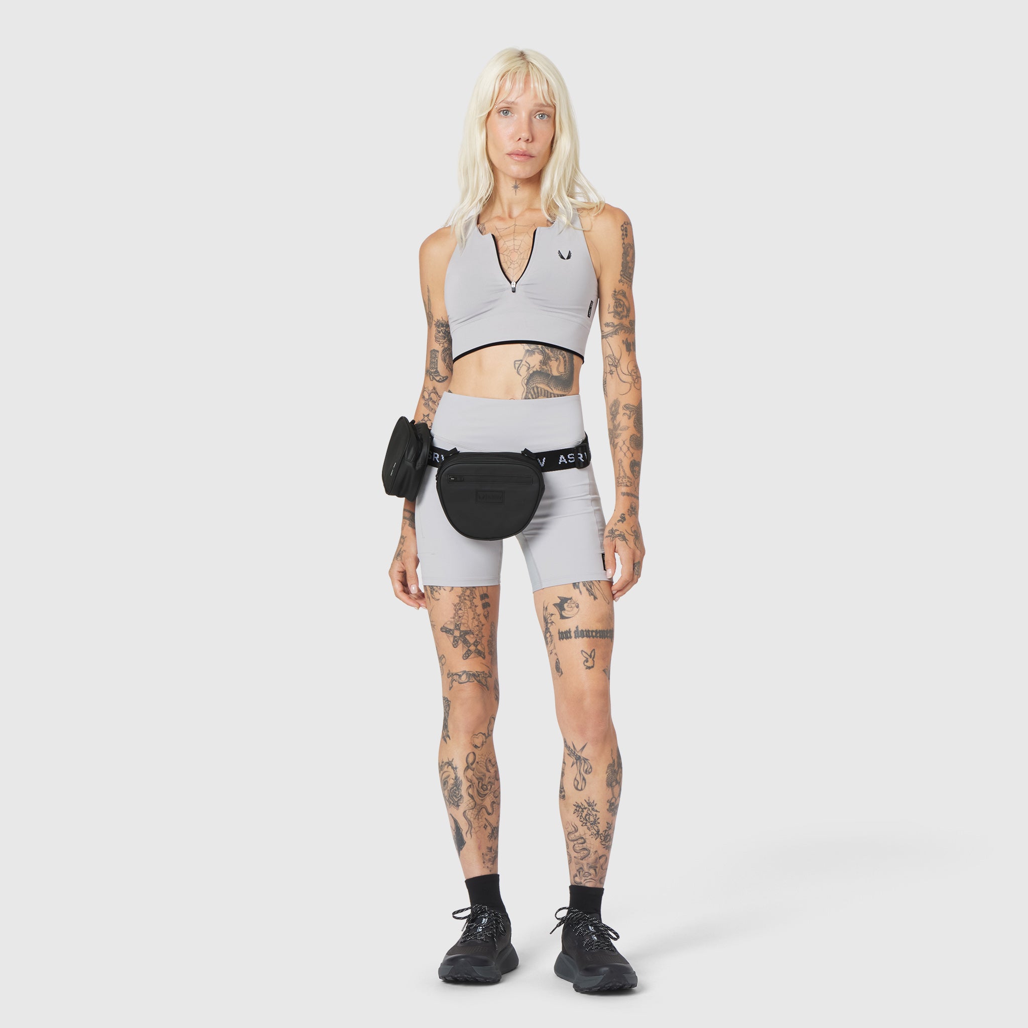 Trail Pack in black, worn on model with white sports bra and shorts