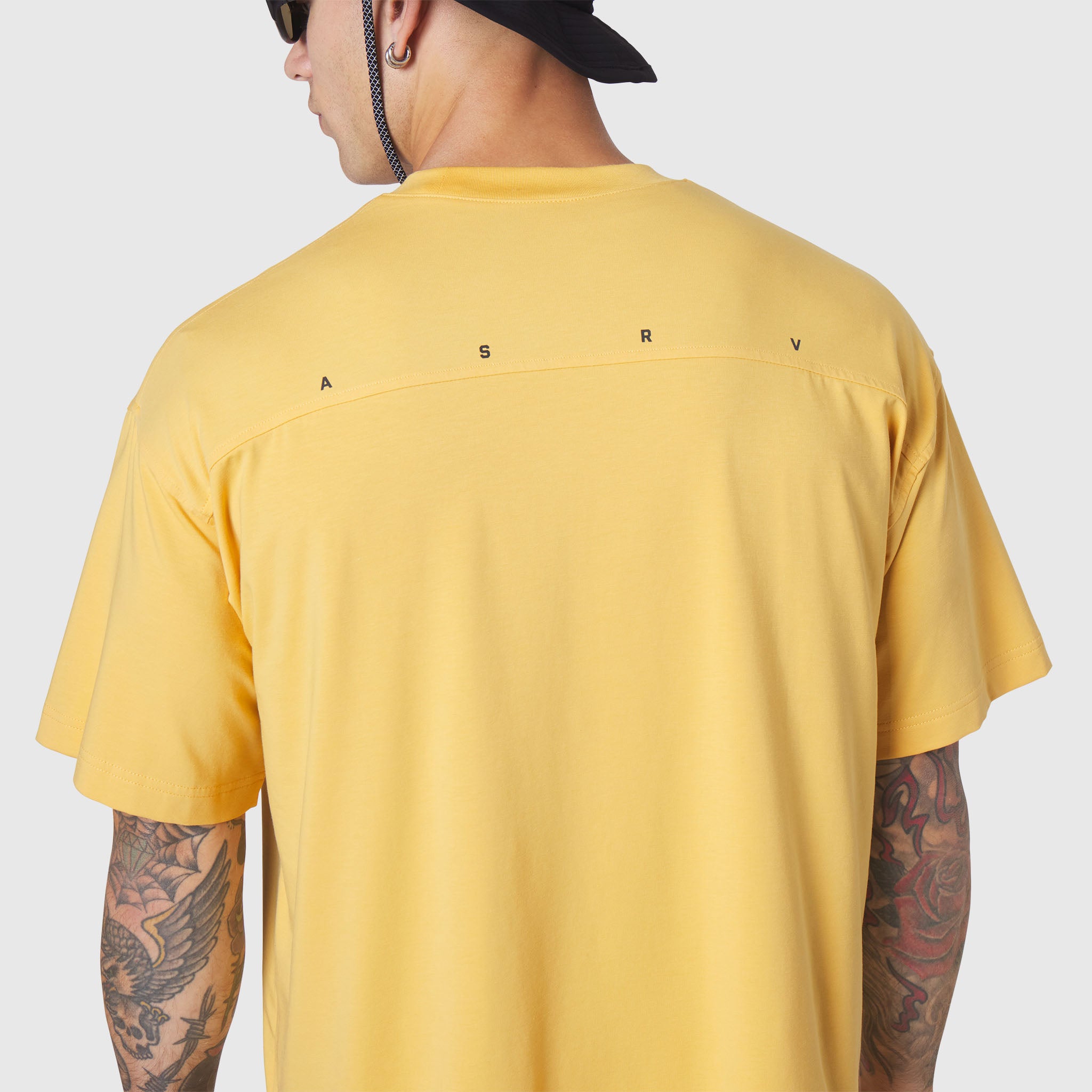 Supima Ice-Skin Reversible Tee in amber yellow, back view on model with tattoos